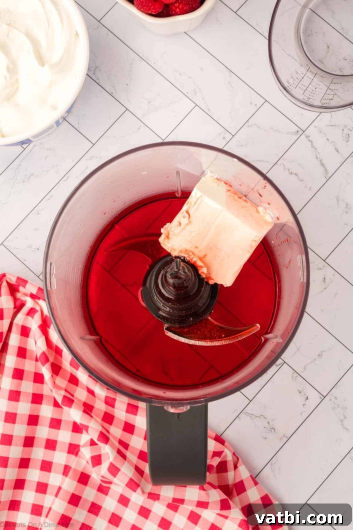 Layered Jello Parfait 6 Cream cheese and dissolved Jello in a food processor, ready to blend.