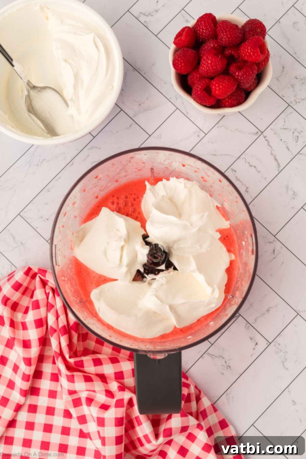 Layered Jello Parfait 8 Whipped topping being added to the Jello and cream cheese mixture.