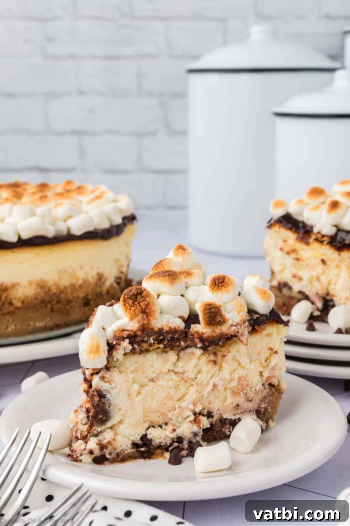 Smores Cheesecake 16 Slice of S'mores cheesecake on a plate, showing all its delicious layers.