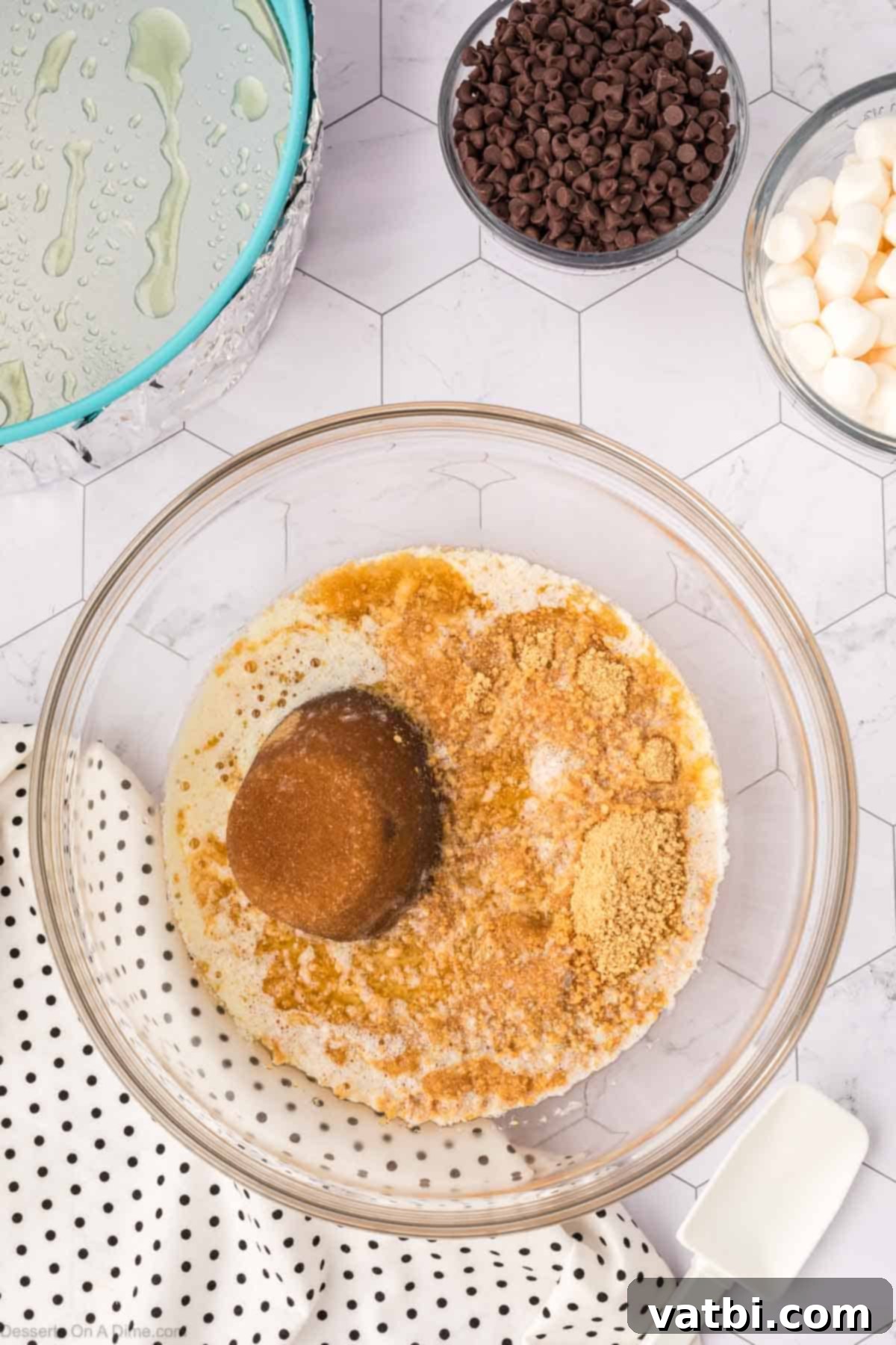Smores Cheesecake 5 Mixing bowl with graham cracker crumbs, brown sugar and melted butter combined.
