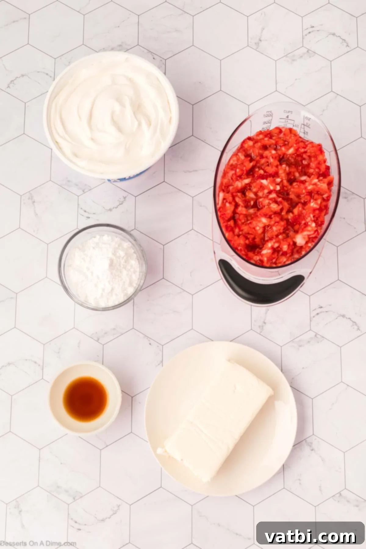 Key ingredients for a luscious cheesecake fluff: softened cream cheese, powdered sugar, vanilla extract, whipped topping, and fresh strawberries.