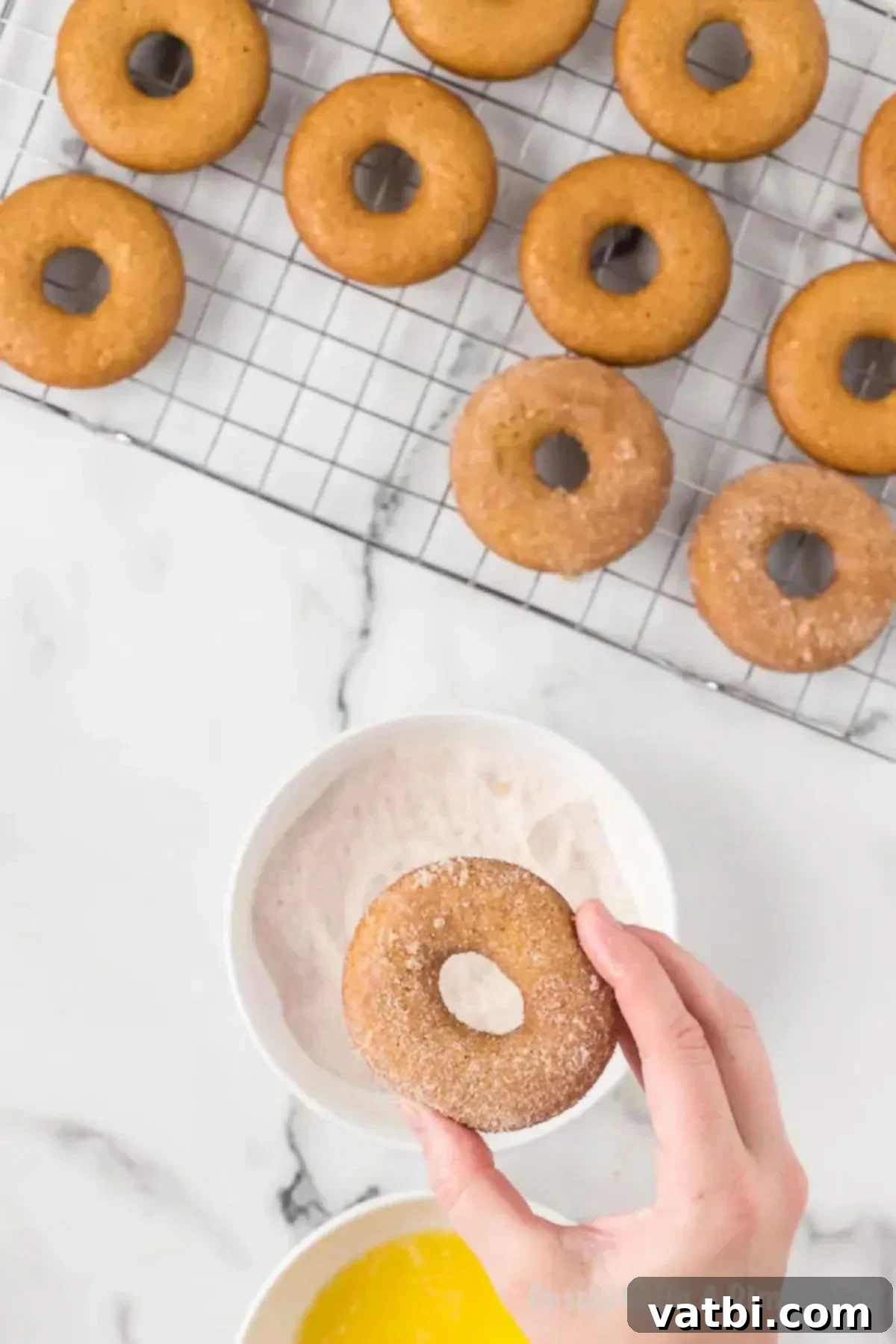 Spiced Apple Cider Baked Doughnuts 9 Donuts dipped in sugar topping.