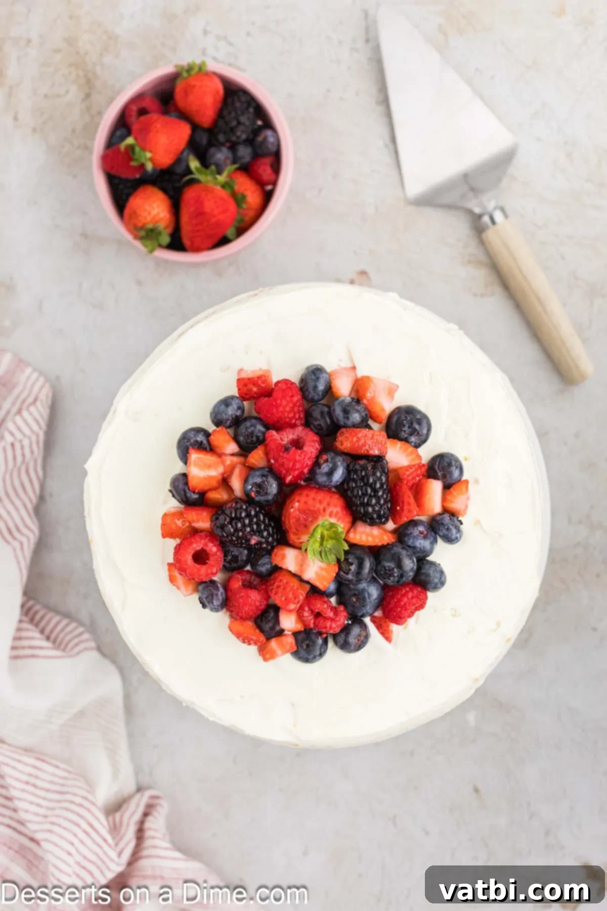 Heavenly Whipped Cream Delight 13 Cake topped with frosting and garnished with fresh berries.