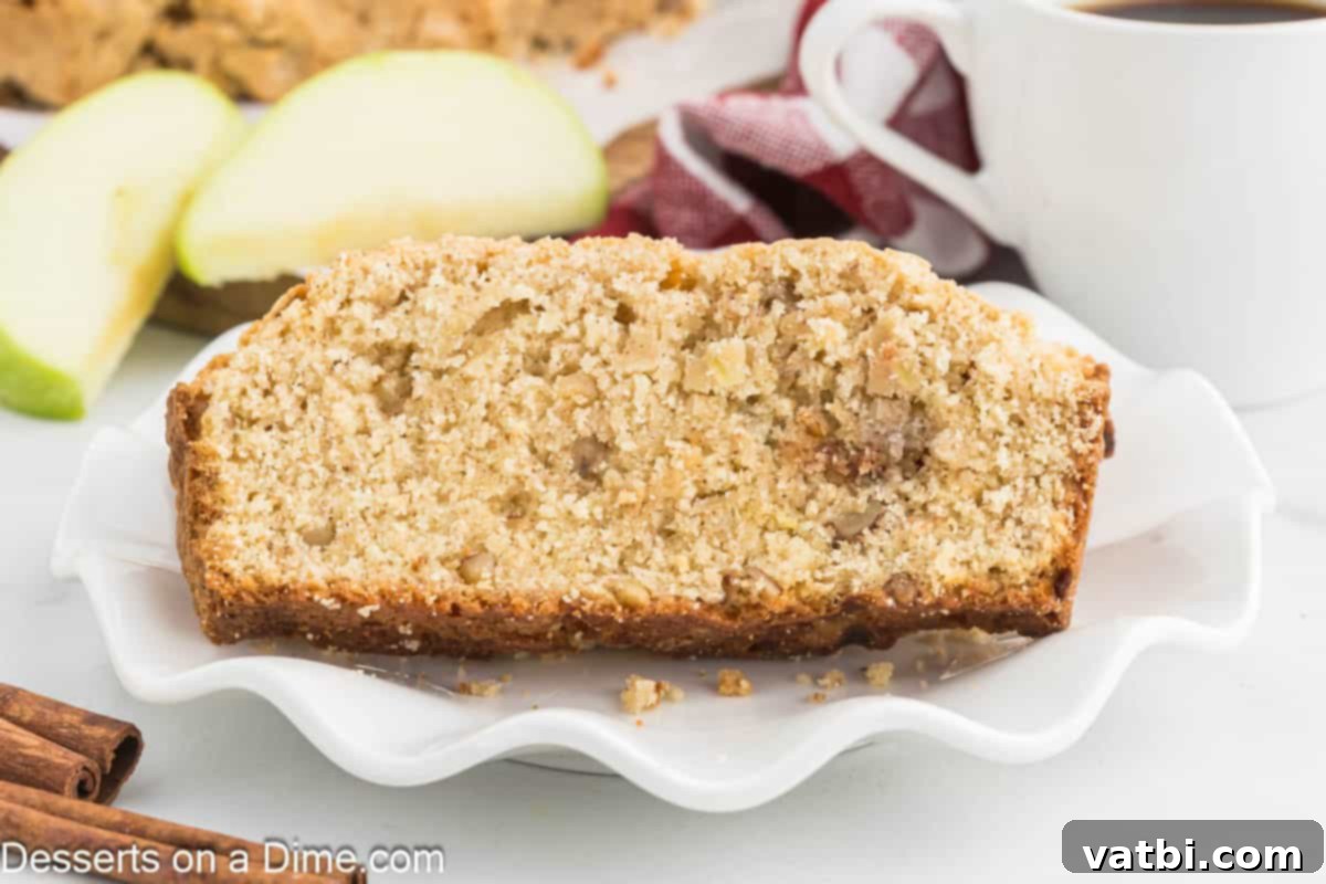 Spiced Apple Loaf 2 Apple bread sliced and ready to serve, showcasing its moist texture and apple chunks.