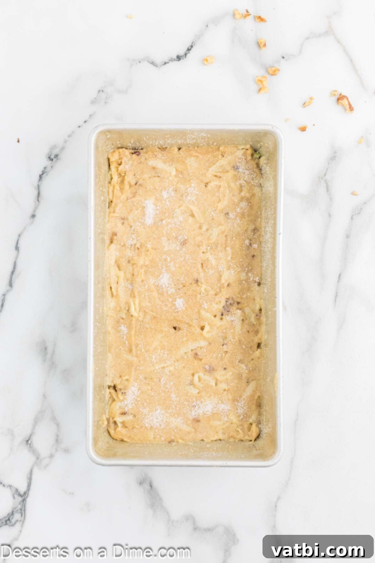 Spiced Apple Loaf 8 Apple bread batter smoothly spread into a prepared loaf pan, ready for baking.