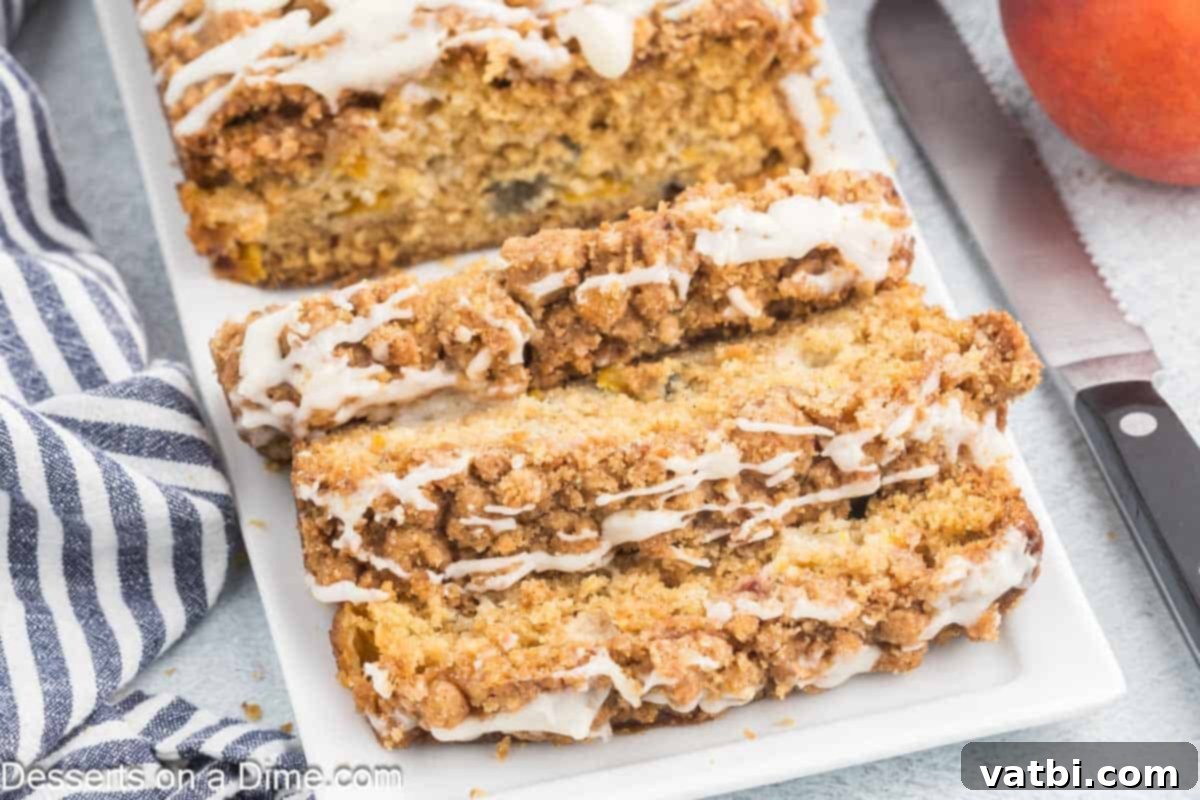 Peach Bread sliced on a white platter, showcasing its moist interior and fruit pieces.