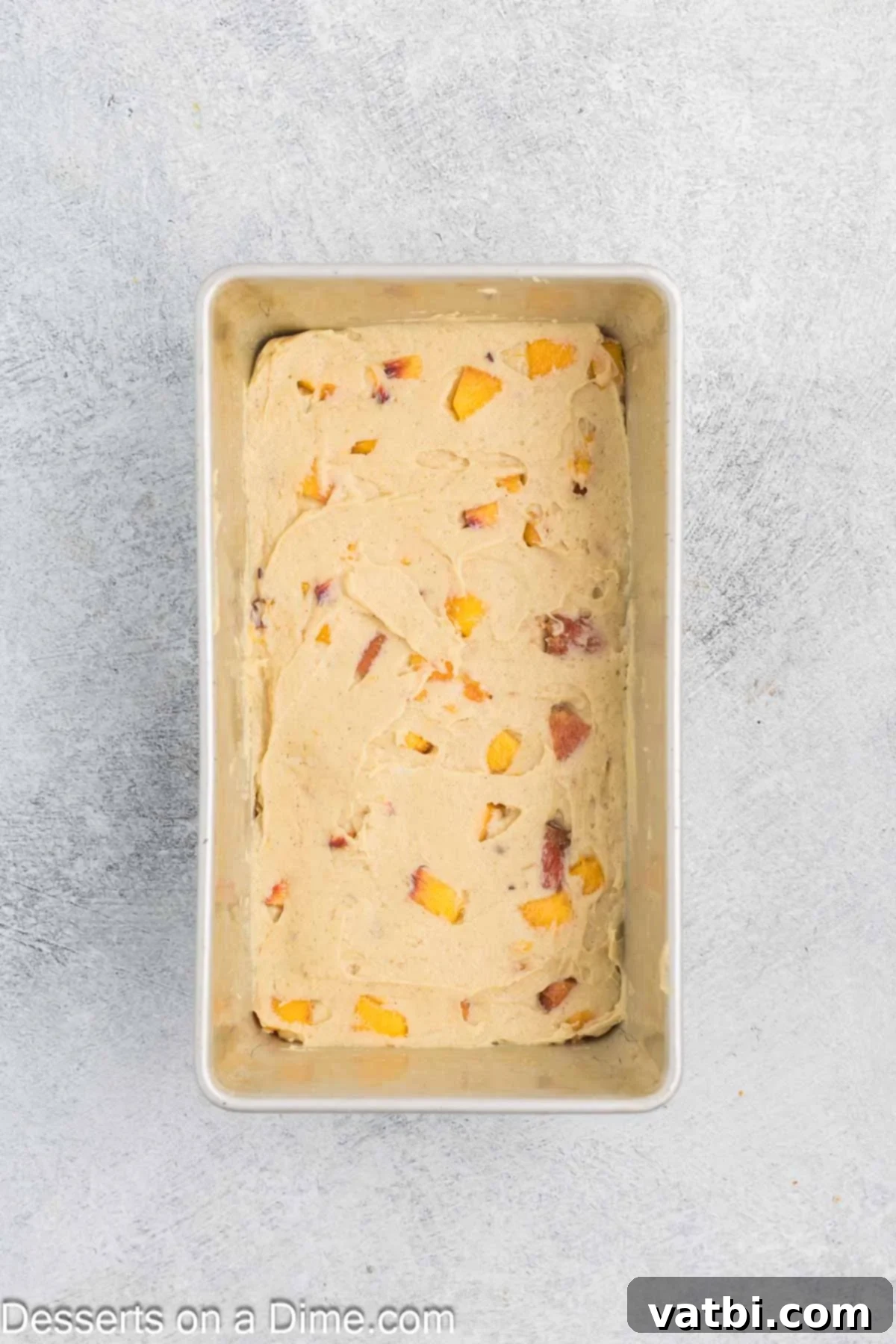 Batter spread evenly into the greased loaf pan, ready for the streusel.