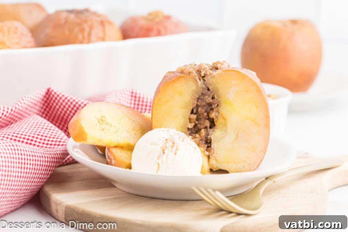 Warm Spiced Baked Apples 1 Two golden-brown baked apples, glistening with sweet syrup, served on a white plate with a melting scoop of vanilla ice cream, creating a delightful contrast.