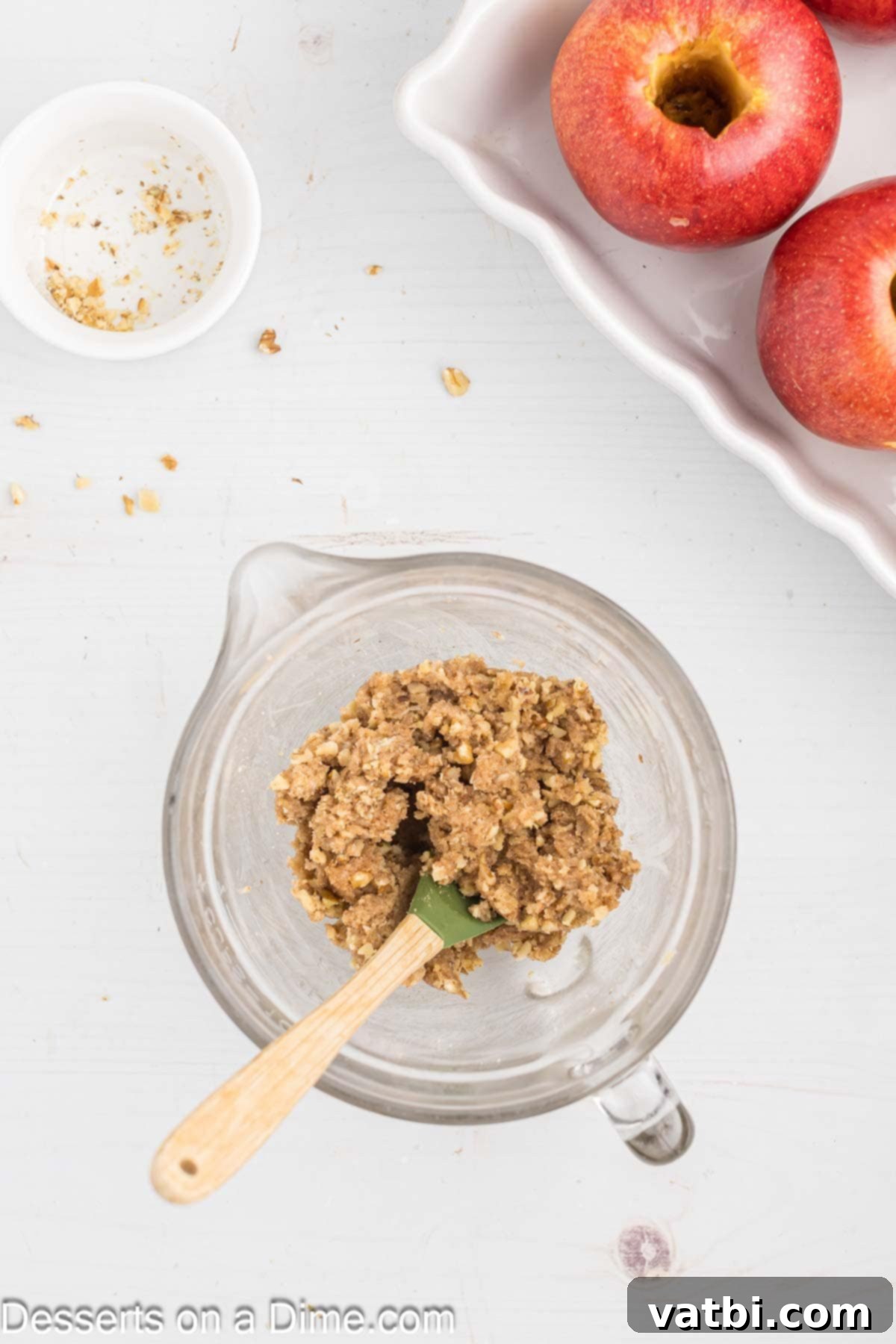 Warm Spiced Baked Apples 4 A mixing bowl filled with the baked apple filling ingredients: rich brown sugar, aromatic cinnamon, softened butter, and crunchy chopped walnuts, all thoroughly combined into a cohesive mixture.