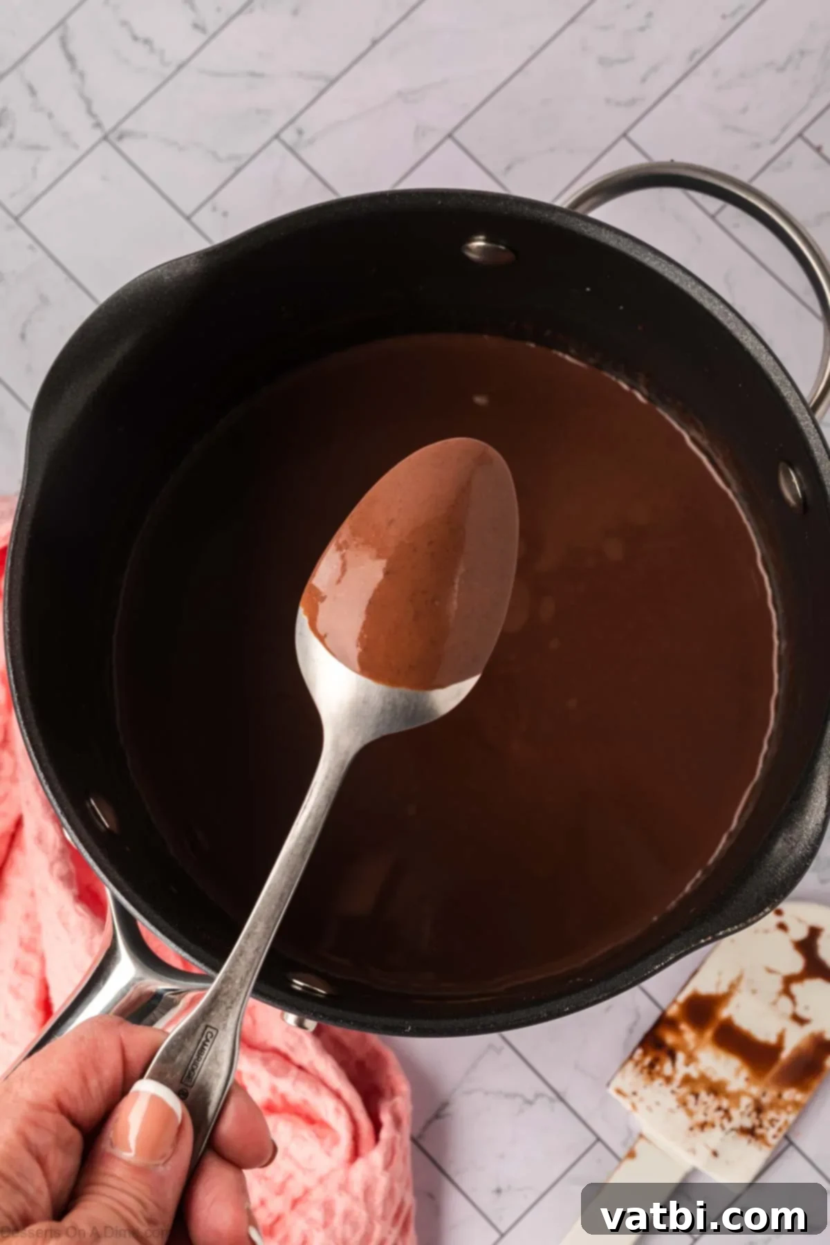 Deep Dark Chocolate Pudding 6 Mixture thickening and coated spoon.