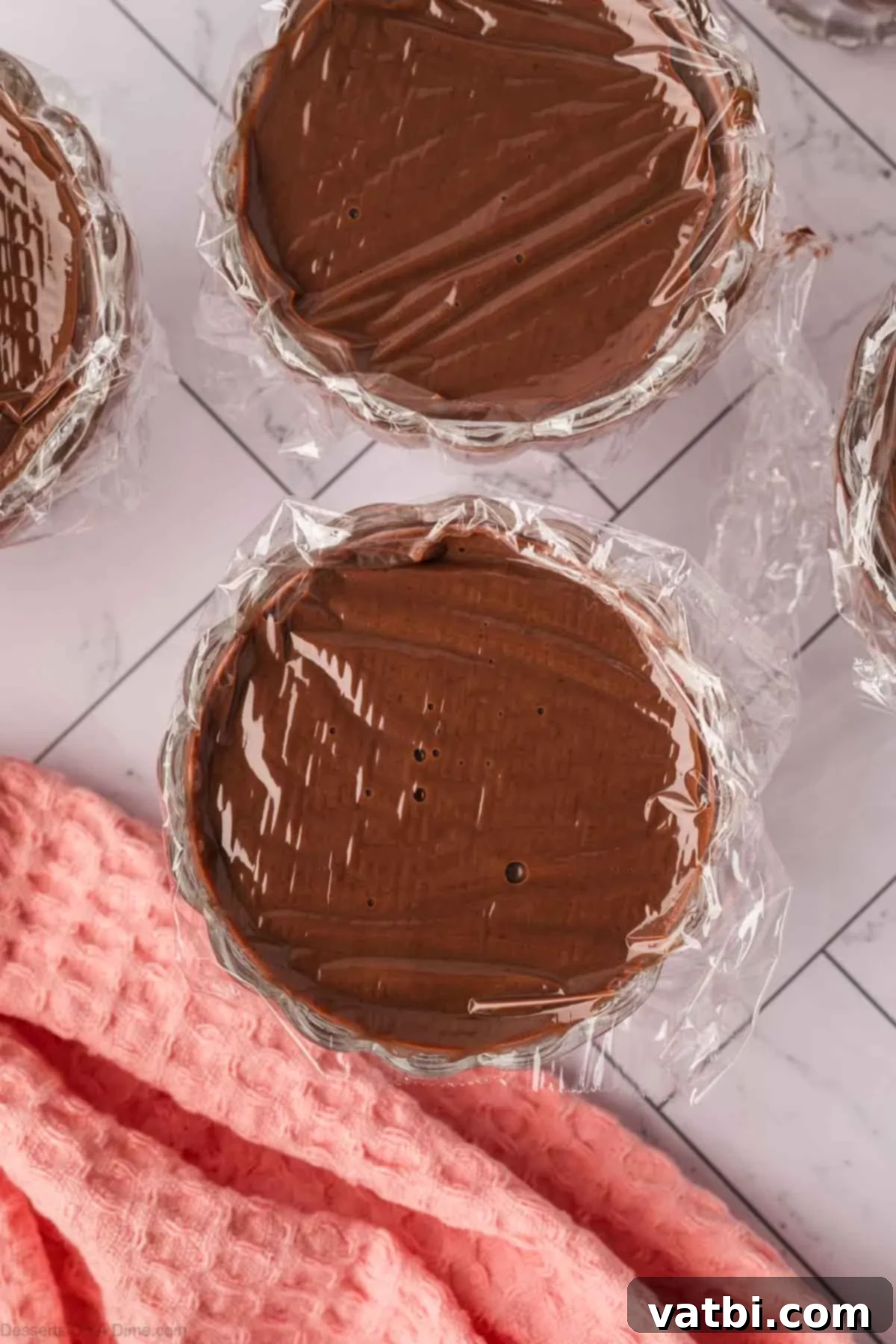 Deep Dark Chocolate Pudding 7 Pudding mixture divided into cups and covered with plastic wrap.