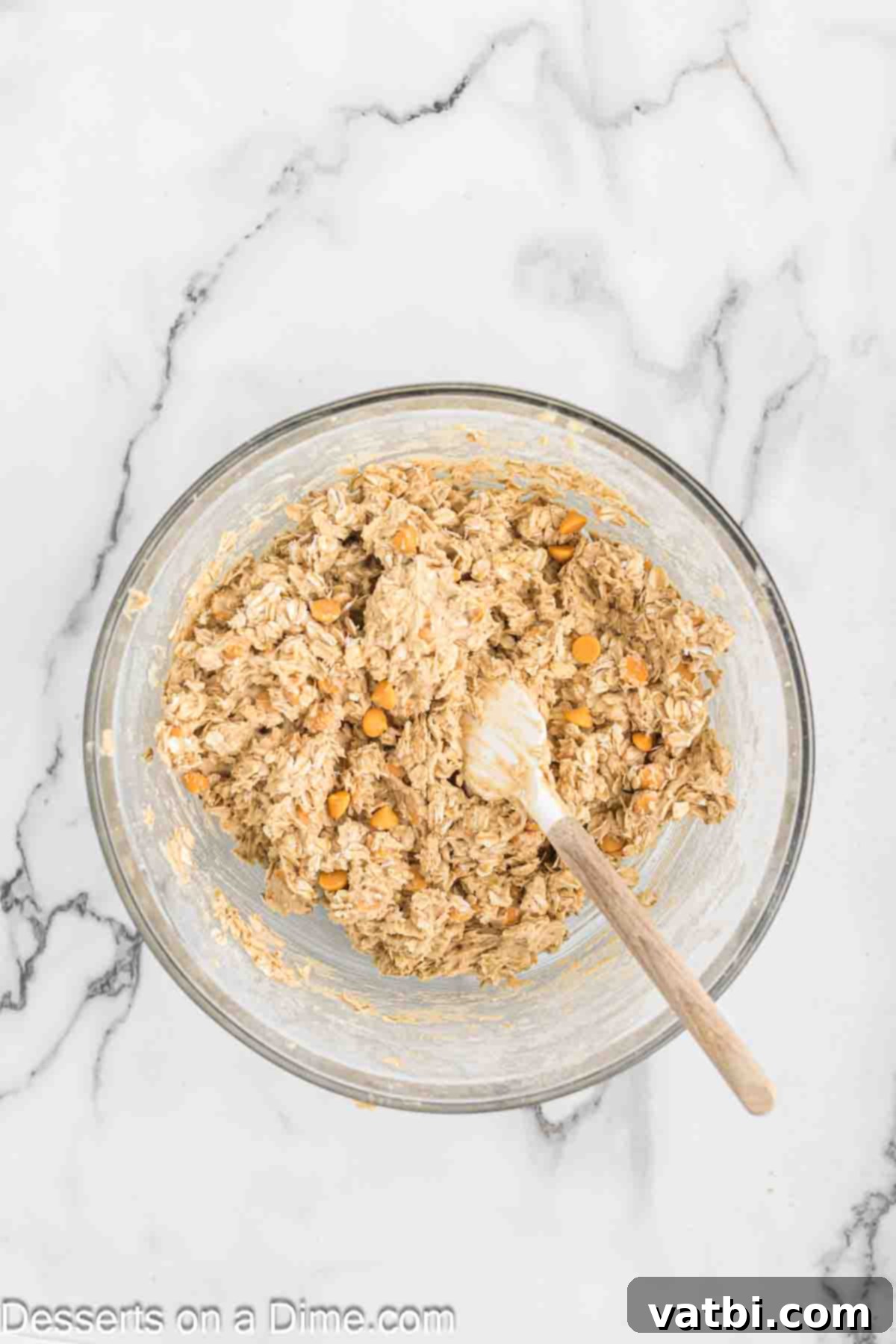 Oatmeal Butterscotch Cookies 6 Mixing bowl with cookie dough and butterscotch chips folded in by hand.