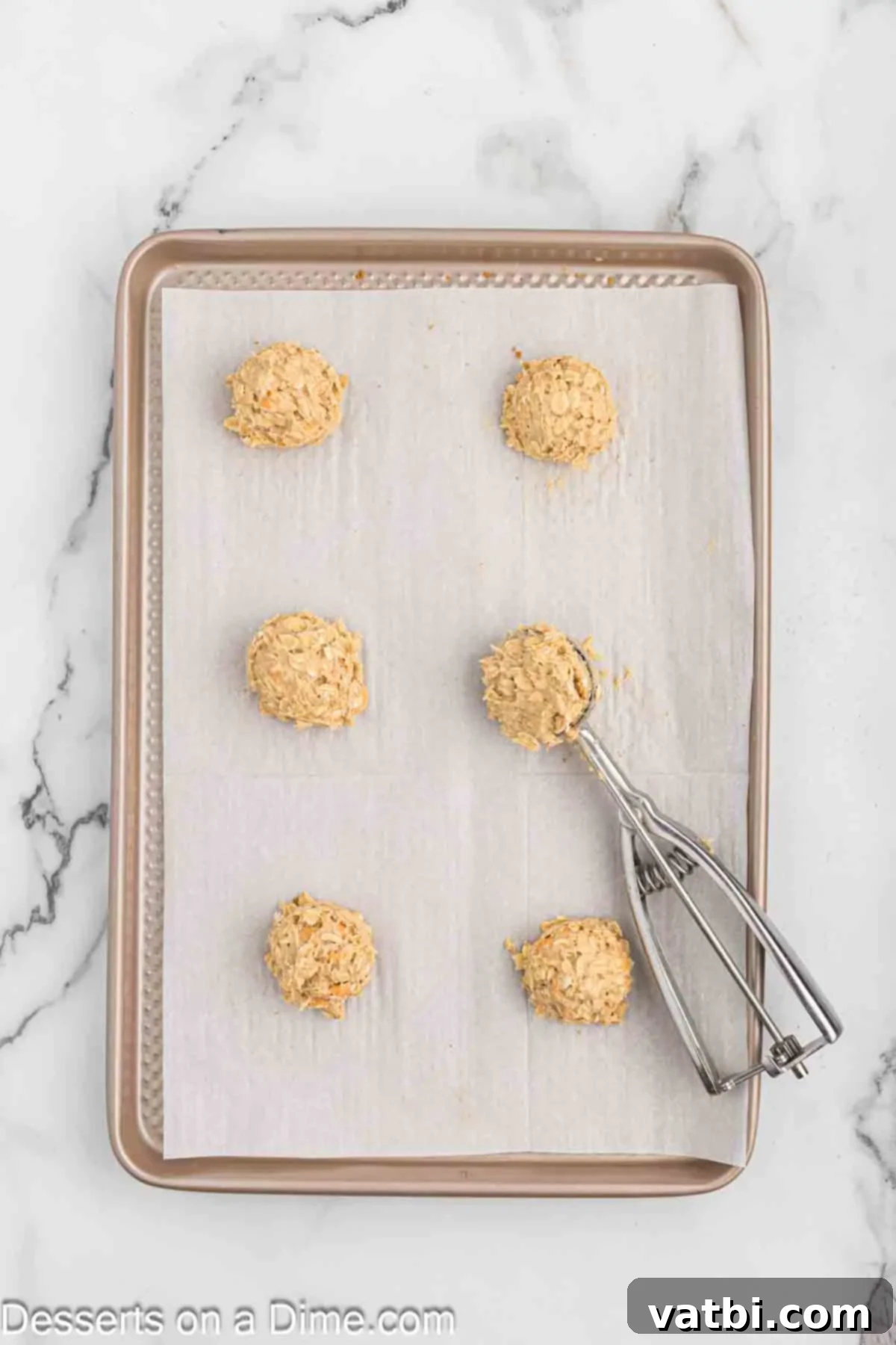 Oatmeal Butterscotch Cookies 7 Cookie dough balls scooped onto a baking sheet, spaced for even baking.