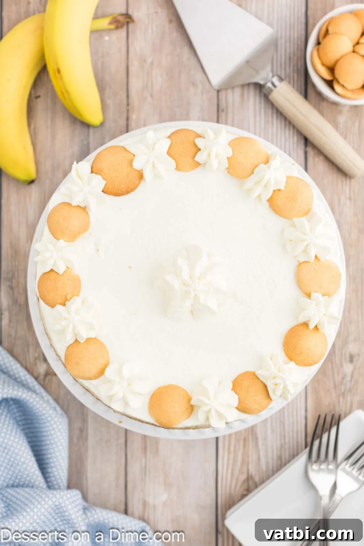 Decadent Banana Cheesecake 12 Banana Cream Cheesecake garnished with whipped topping and fresh banana slices.