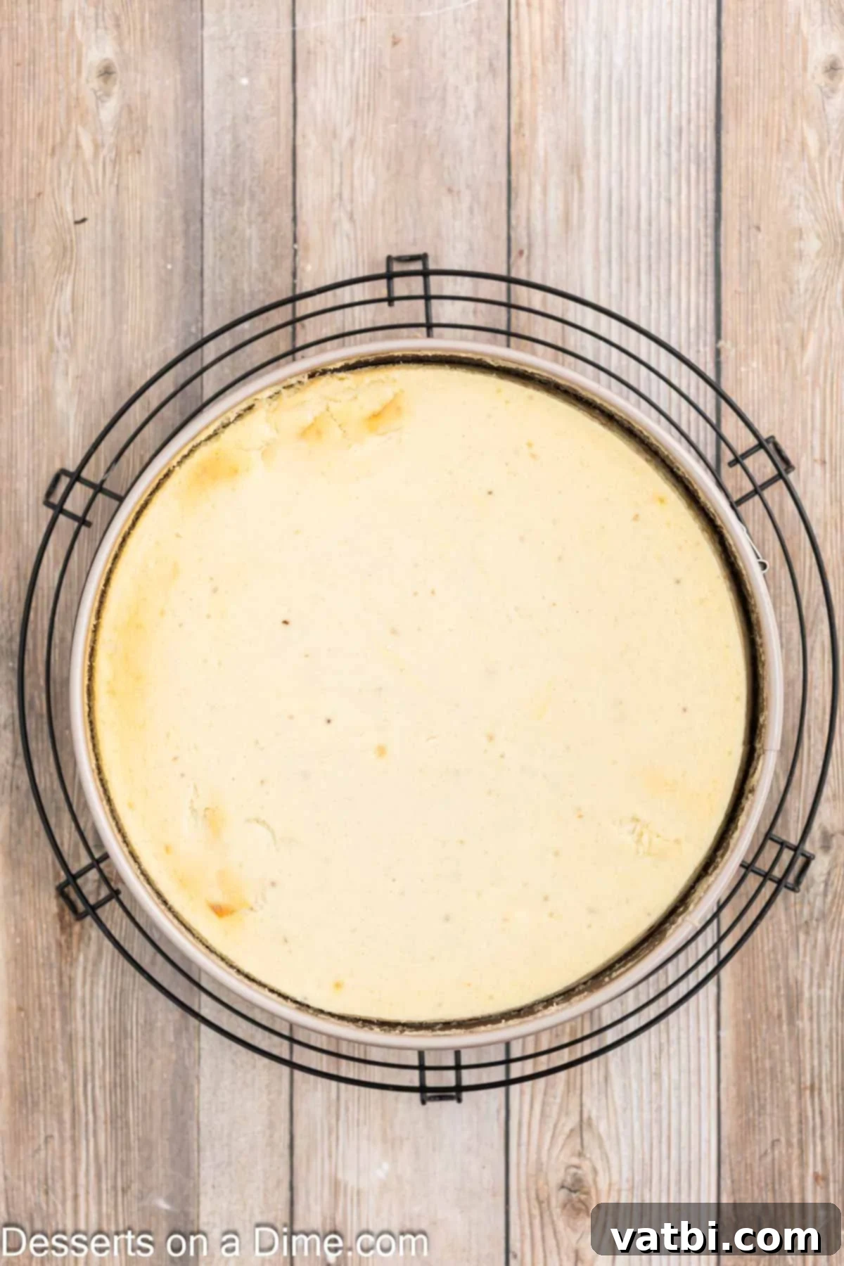 Decadent Banana Cheesecake 10 Cheesecake cooling on a wire rack after baking.