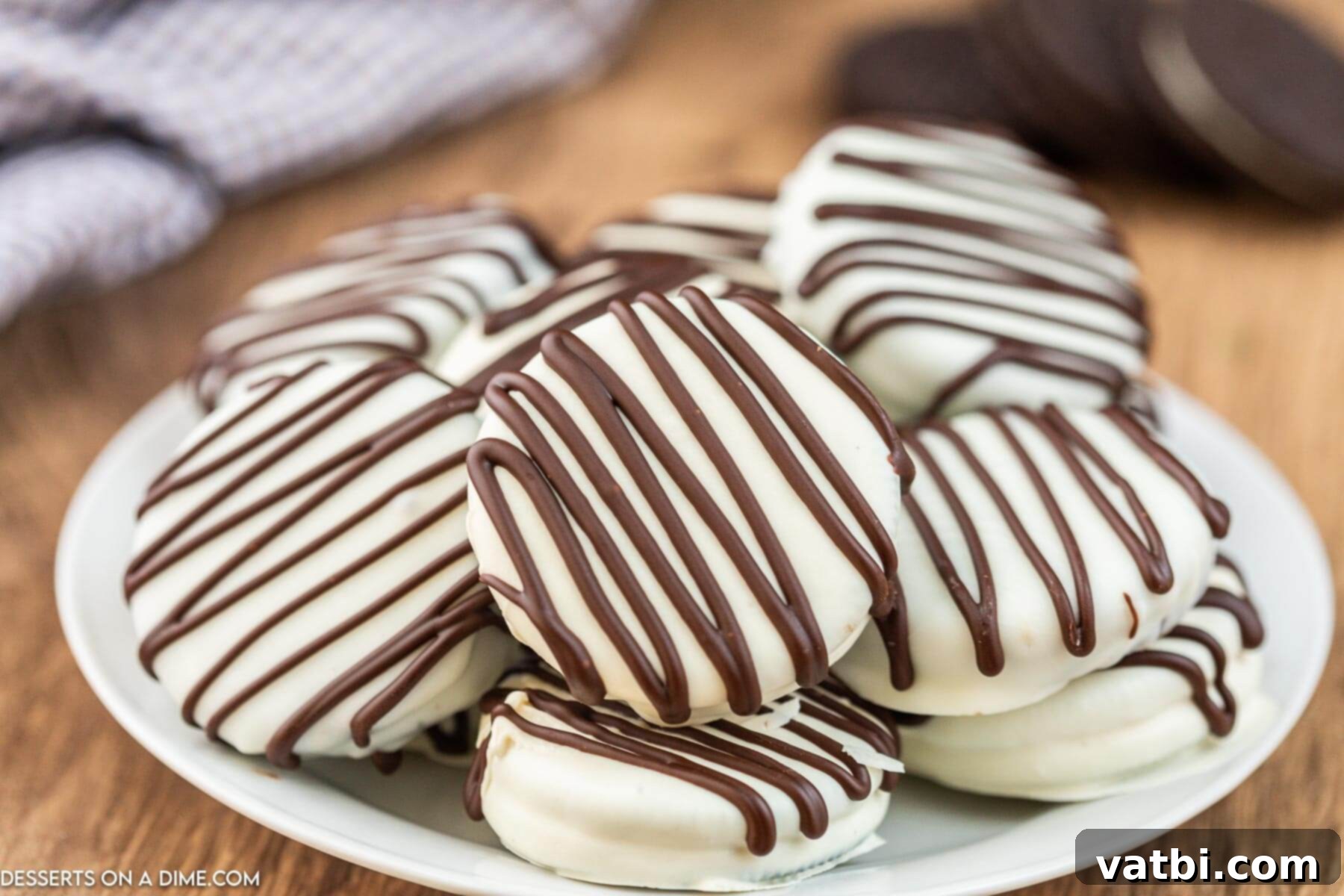 Decadent White Chocolate Oreos 2 Chocolate Covered Oreo Cookies on a platter, showcasing their elegant simplicity.