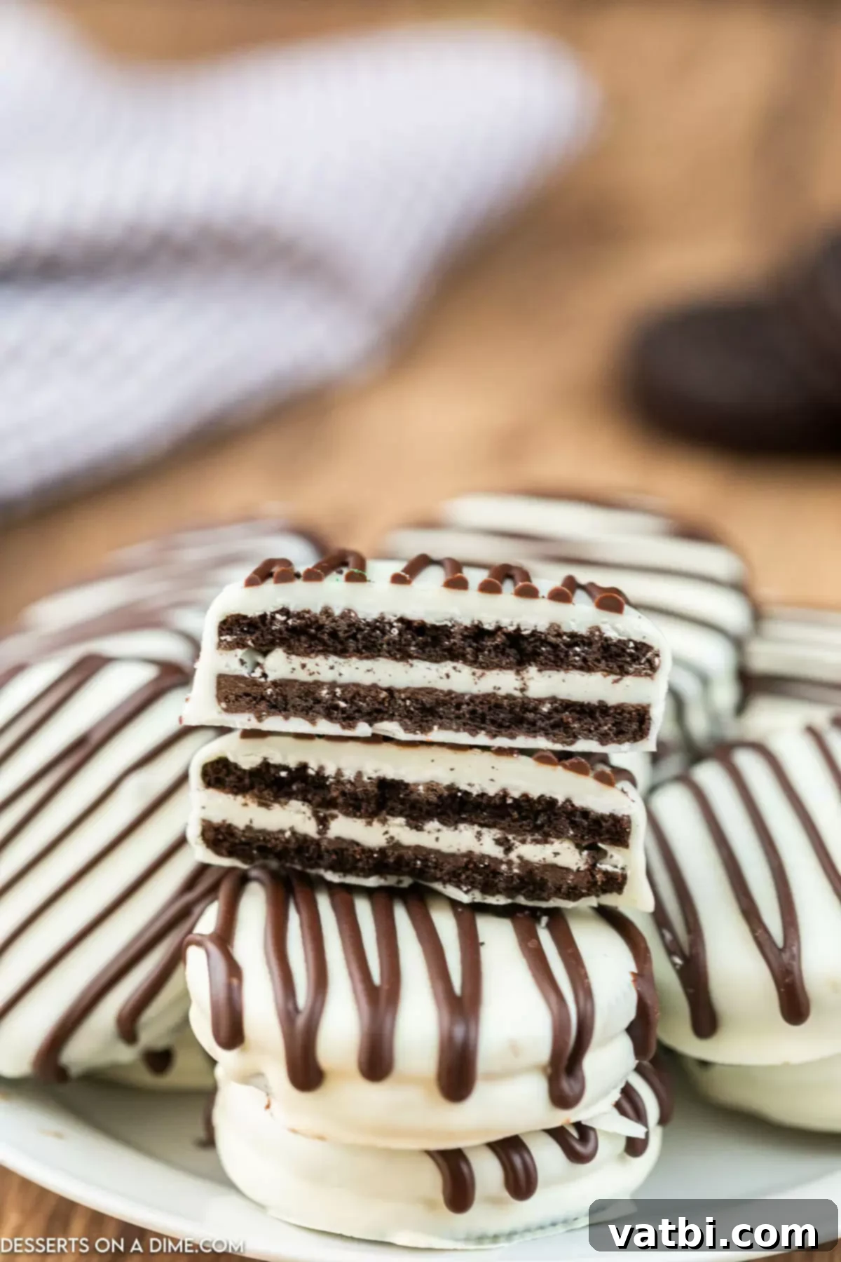 Decadent White Chocolate Oreos 7 White chocolate covered Oreos stacked artfully, highlighting their pristine appearance.