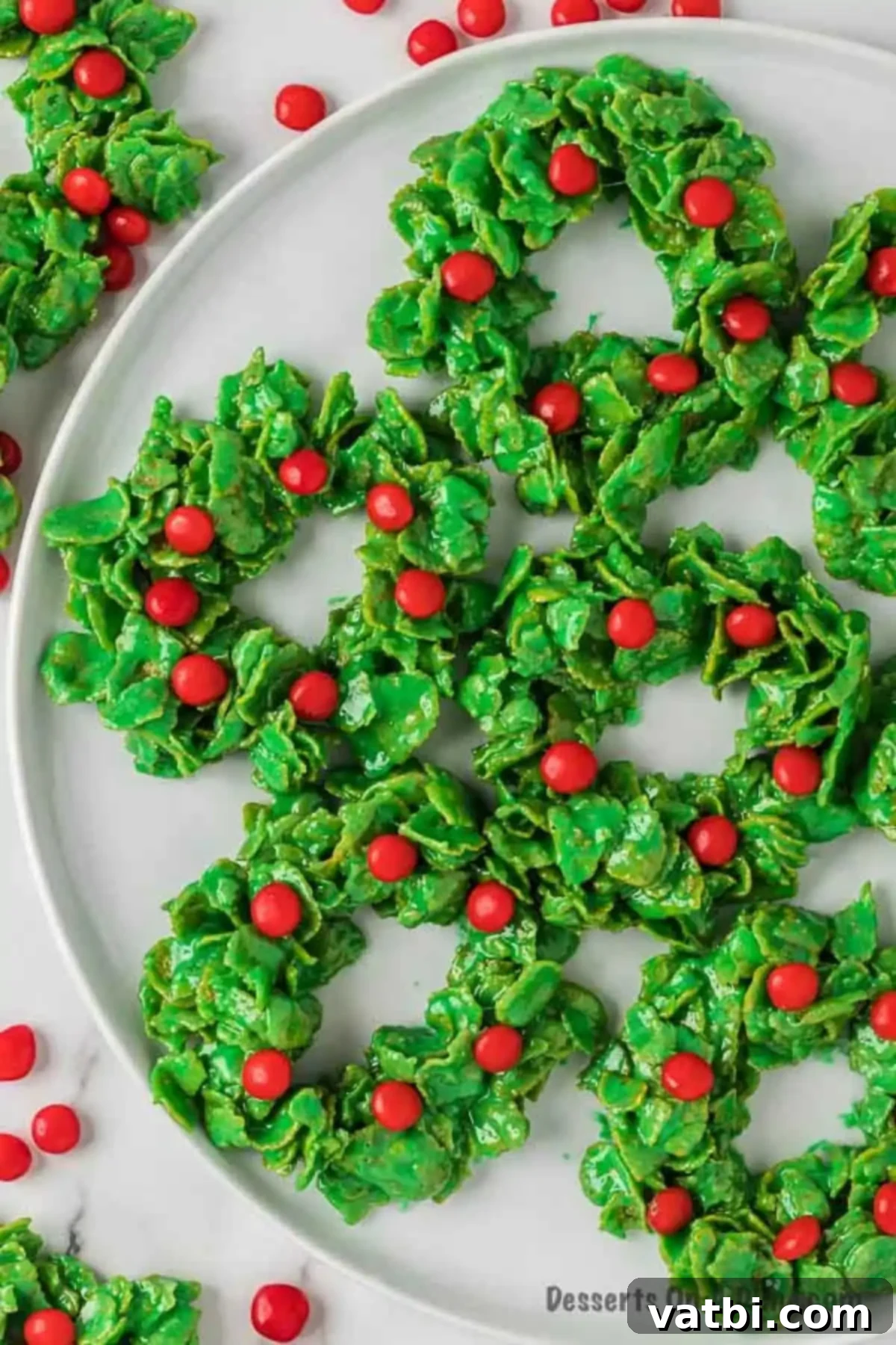 Sweet Christmas Wreath Delights 2 Platter of adorable green Christmas wreath cookies with red candy decorations.