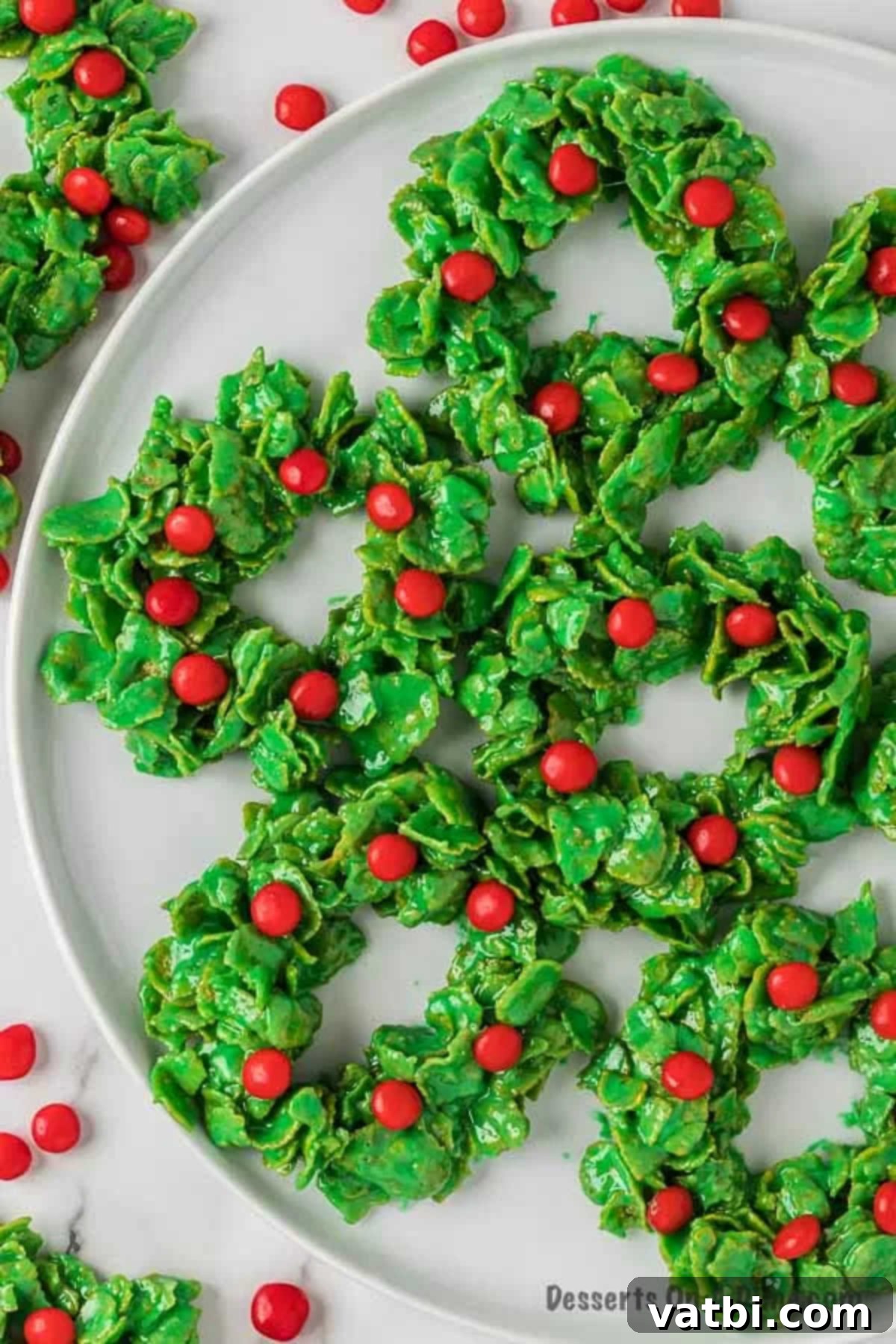 Sweet Christmas Wreath Delights 9 Close-up of a finished Christmas wreath cookie with red hot candies, ready to be served.