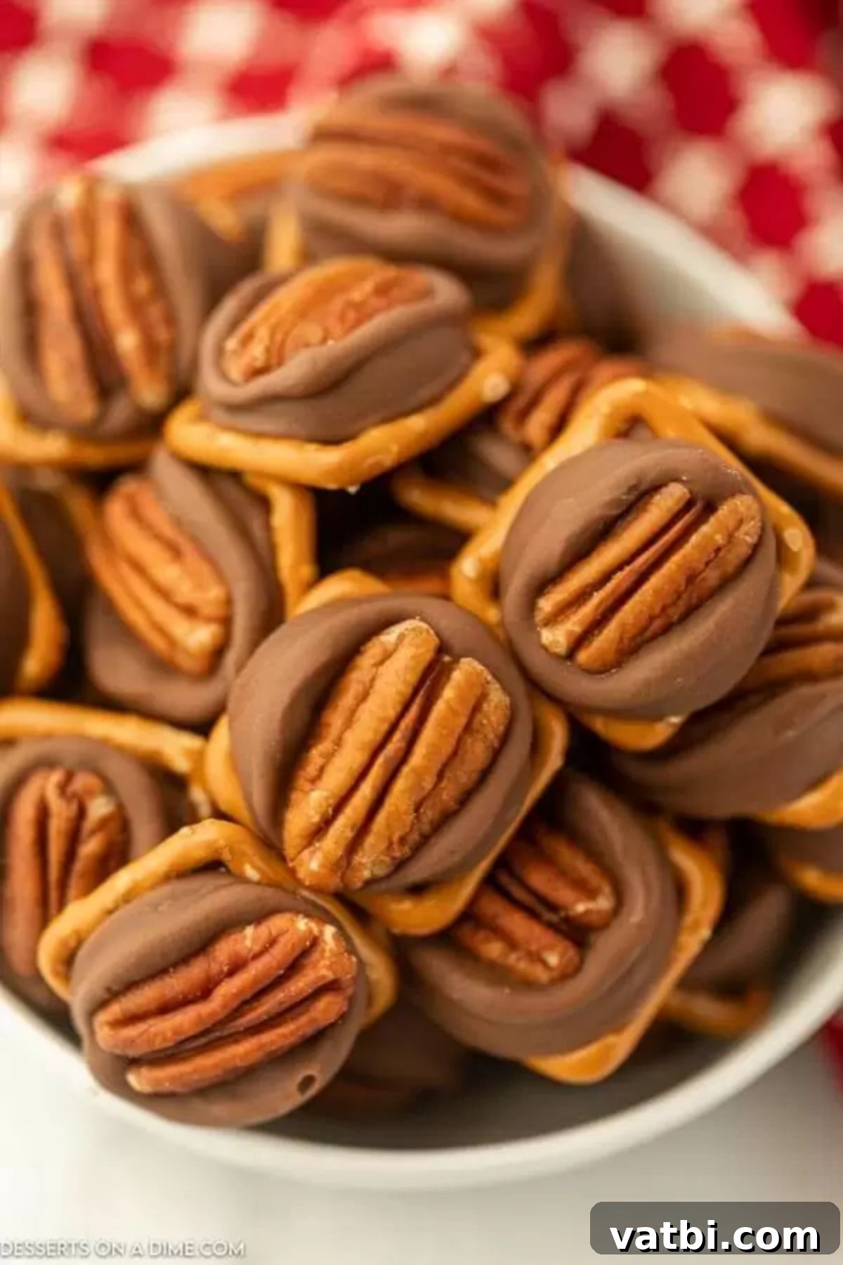 A bowl overflowing with freshly made Rolo Pretzel Turtles, highlighting their sweet and salty perfection.