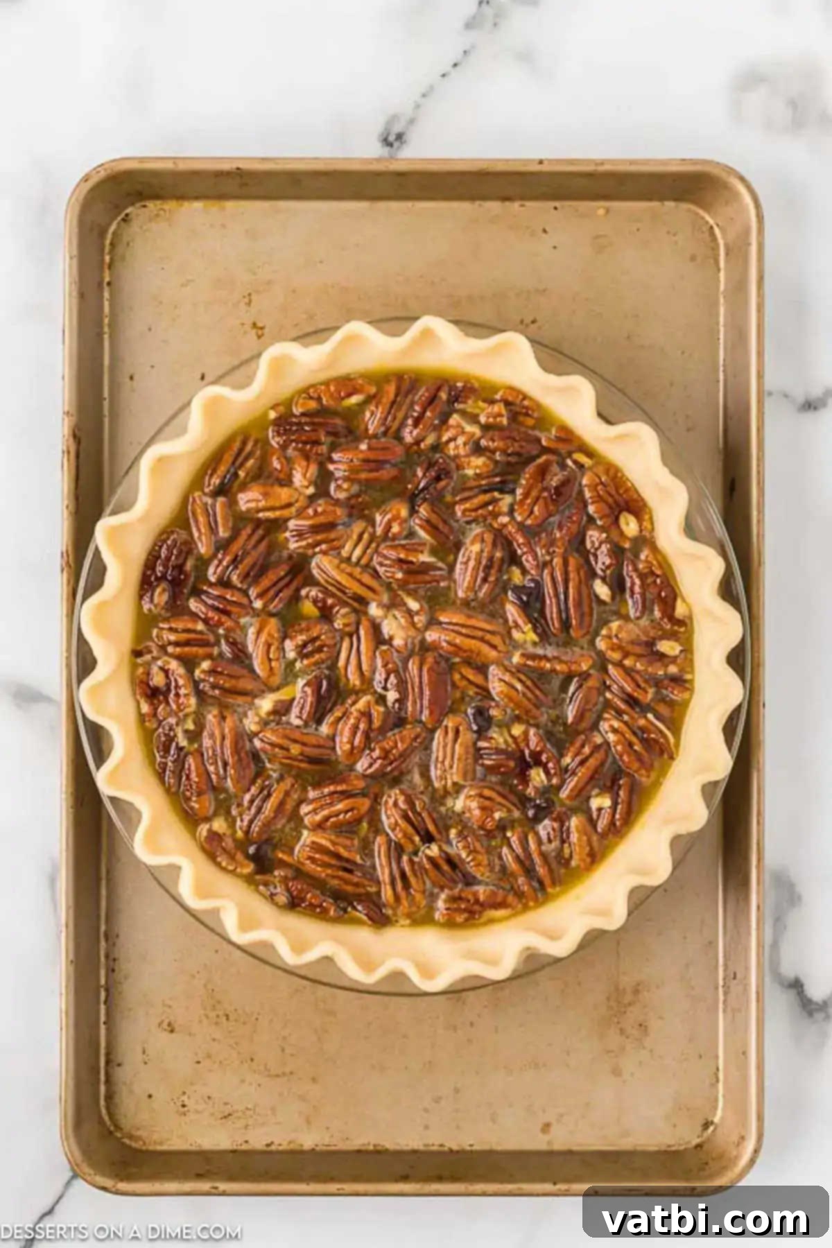 Pie plate resting on a baking sheet to catch any potential spills during baking. 