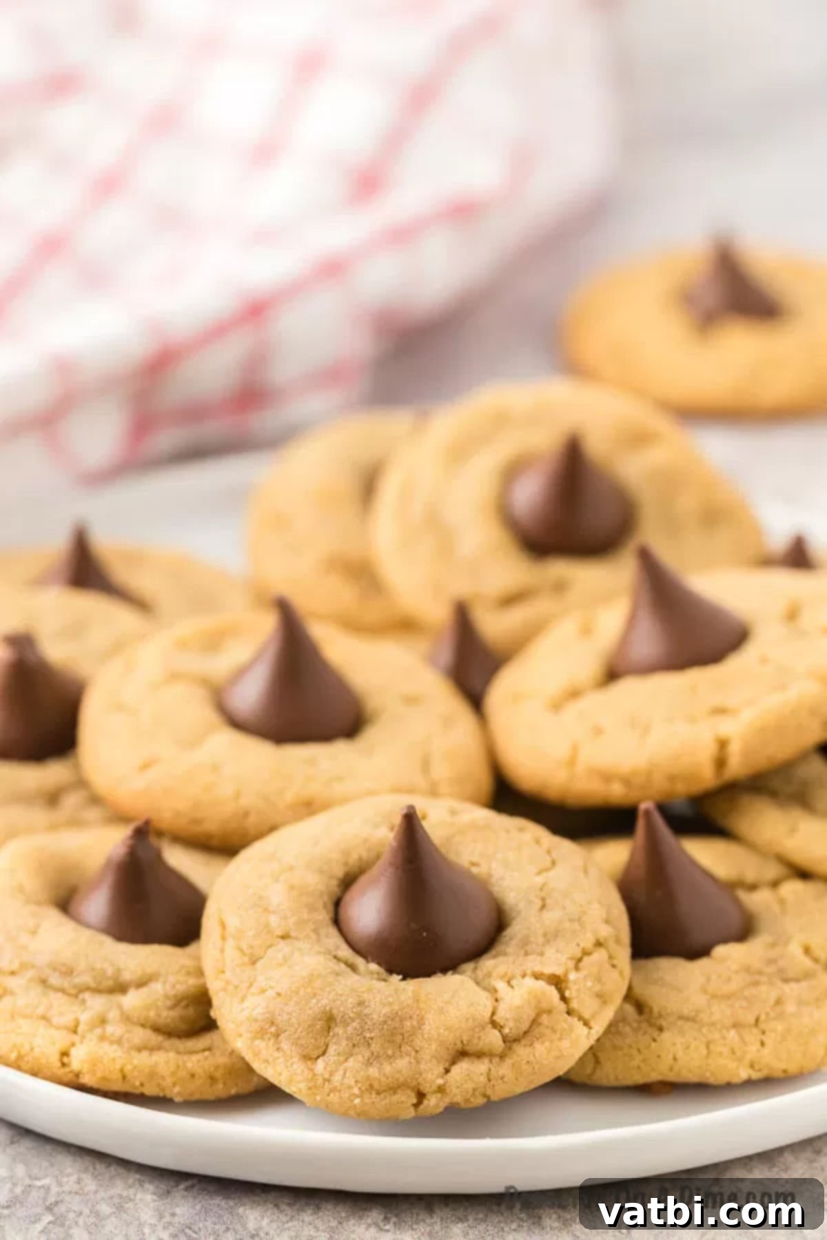 Chocolate-Kissed Peanut Butter Delights 9 Plate of Peanut butter kiss cookies stacked together, showing their irresistible texture.