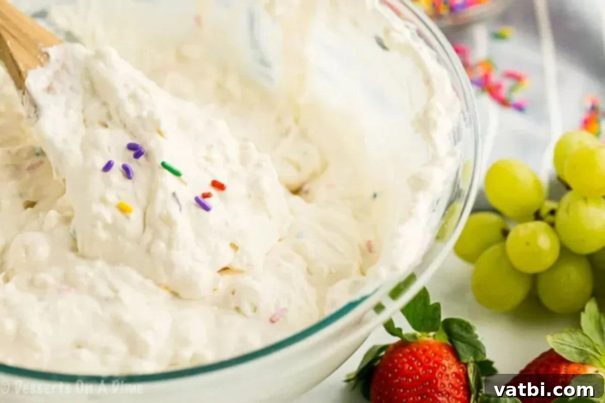 Birthday Cake Batter Dip 4 Mixing bowl with all ingredients combined, showing a smooth and colorful cake batter dip.