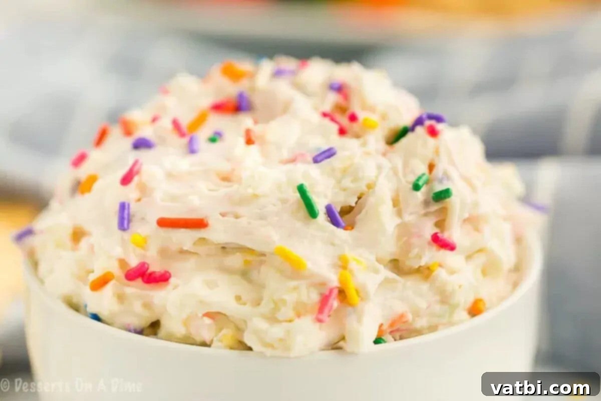 Birthday Cake Batter Dip 5 A serving bowl filled with the finished cake batter dip, generously topped with bright, festive sprinkles.