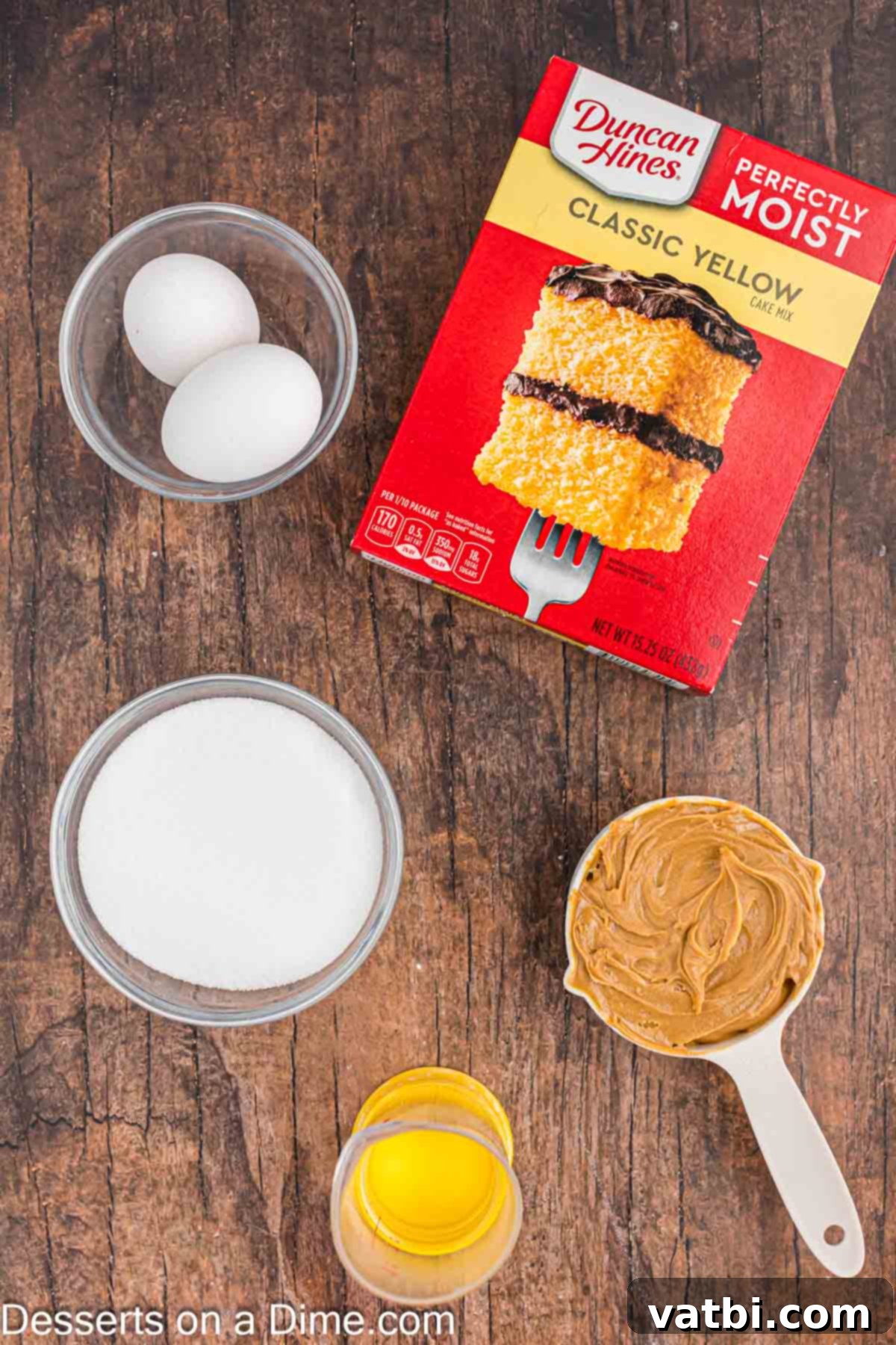 Peanut Butter Cake Mix Cookie Bliss 3 A visual display of the key ingredients for Peanut Butter Cake Mix Cookies: a box of yellow cake mix, creamy peanut butter, and granulated sugar.