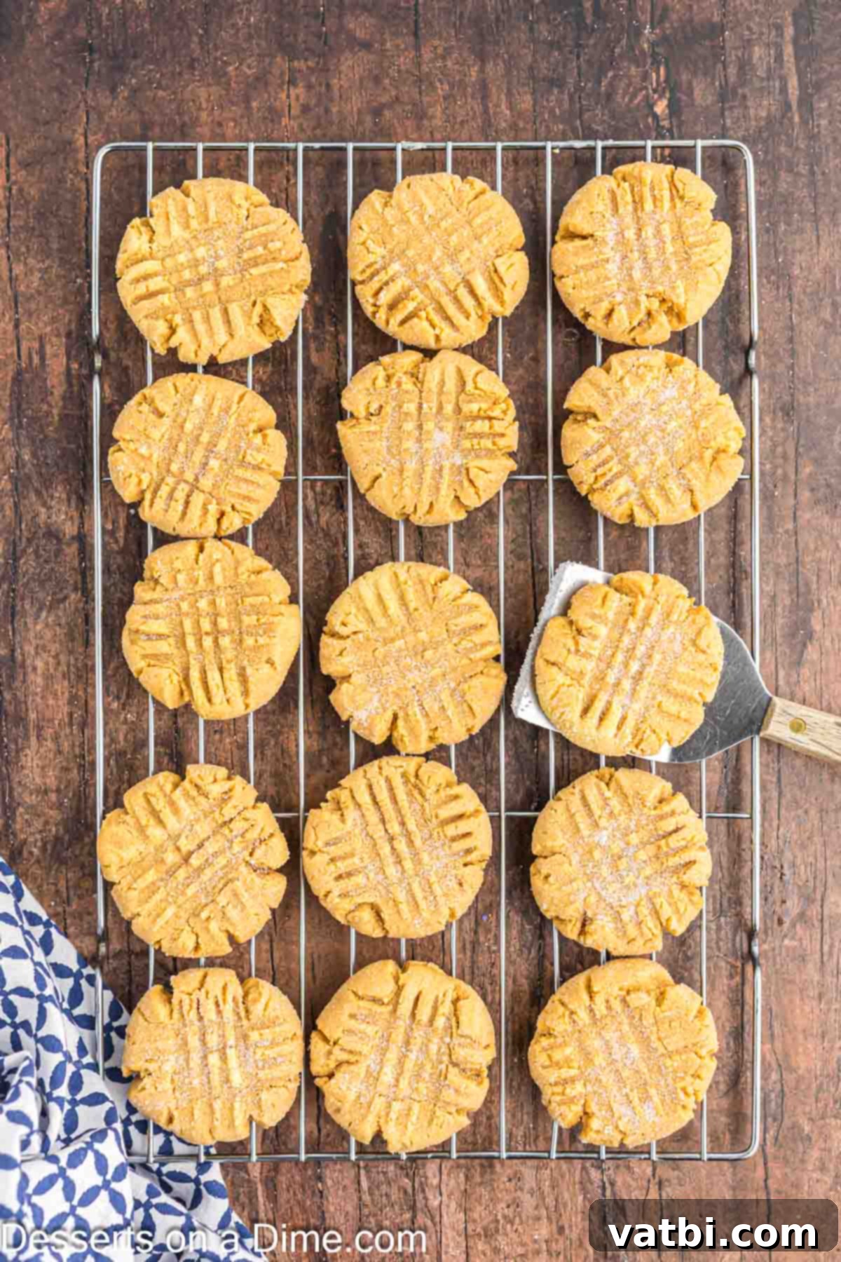 Peanut Butter Cake Mix Cookie Bliss 7 Warm, golden-brown Peanut Butter Cake Mix Cookies resting on a wire rack to cool, allowing them to firm up perfectly.