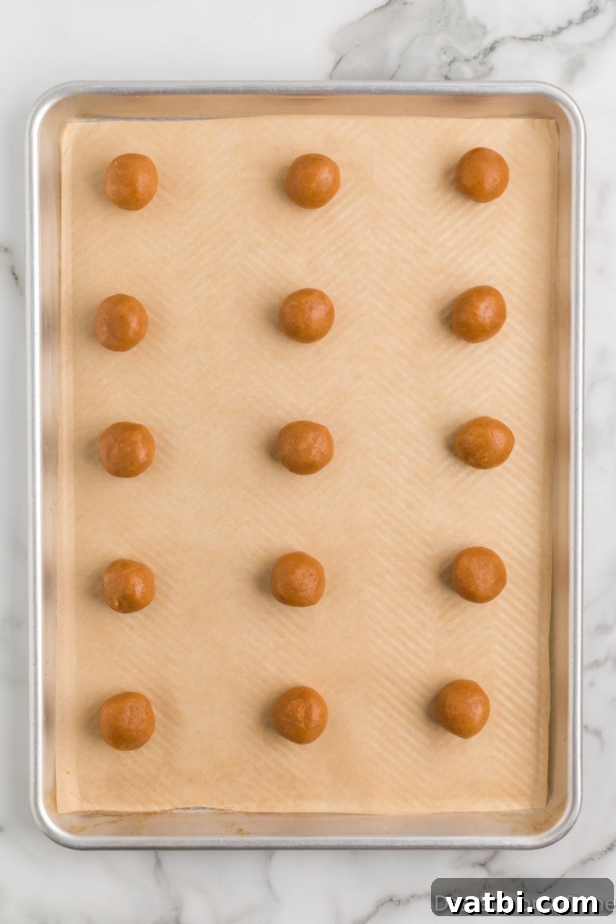 Dough balls on baking sheet.