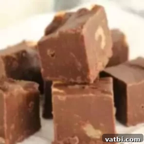 60 Festive and Simple Christmas Sweets 8 Quick and easy Microwave Fudge with visible nut pieces.