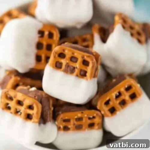 60 Festive and Simple Christmas Sweets 11 Bite-sized Snicker Chocolate Pretzels with caramel and chocolate.