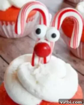 60 Festive and Simple Christmas Sweets 15 Cute Reindeer Cupcakes with pretzel antlers and candy decorations.