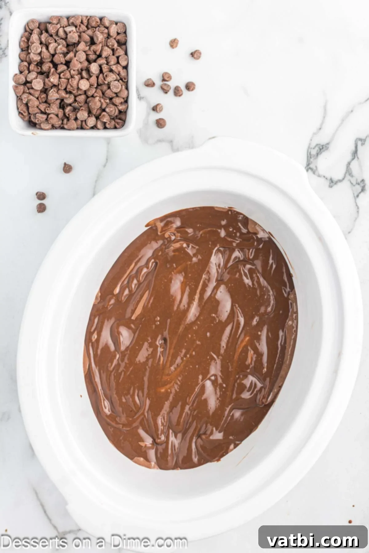 Crock-Pot Molten Chocolate Dream 6 Pudding mixture being spread over the top of the cake batter in the crock pot.
