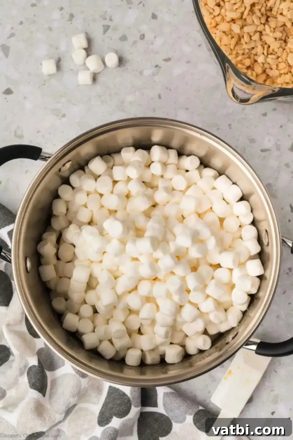 Irresistible Salted Caramel Rice Krispies 5 Mini marshmallows in a pan.