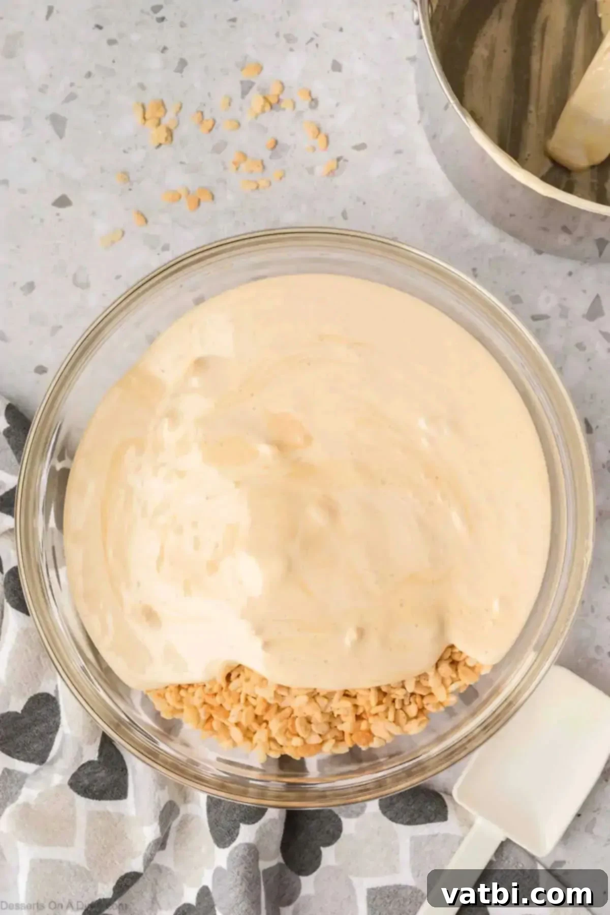 Irresistible Salted Caramel Rice Krispies 6 Melted marshmallows in bowl with cereal.