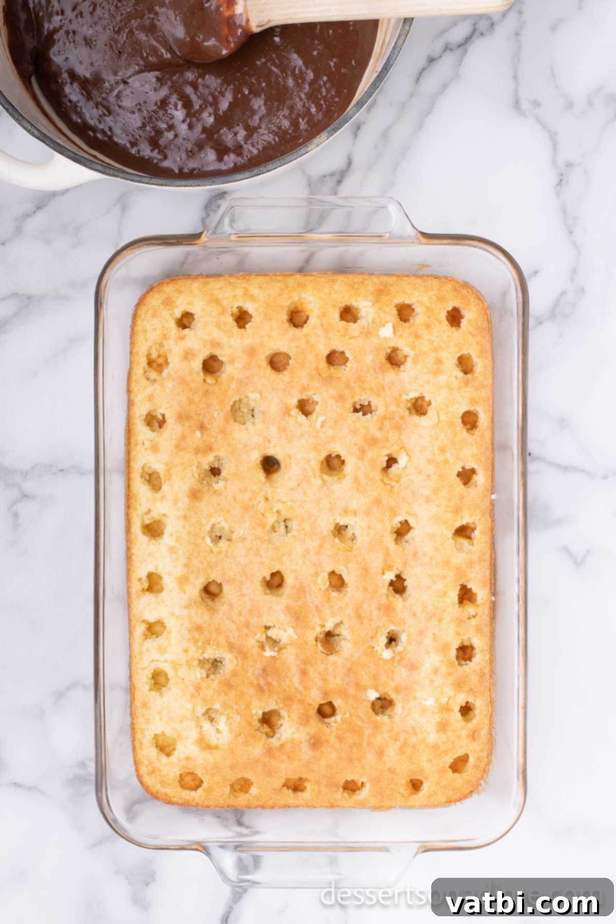 Holes poked in cake. 