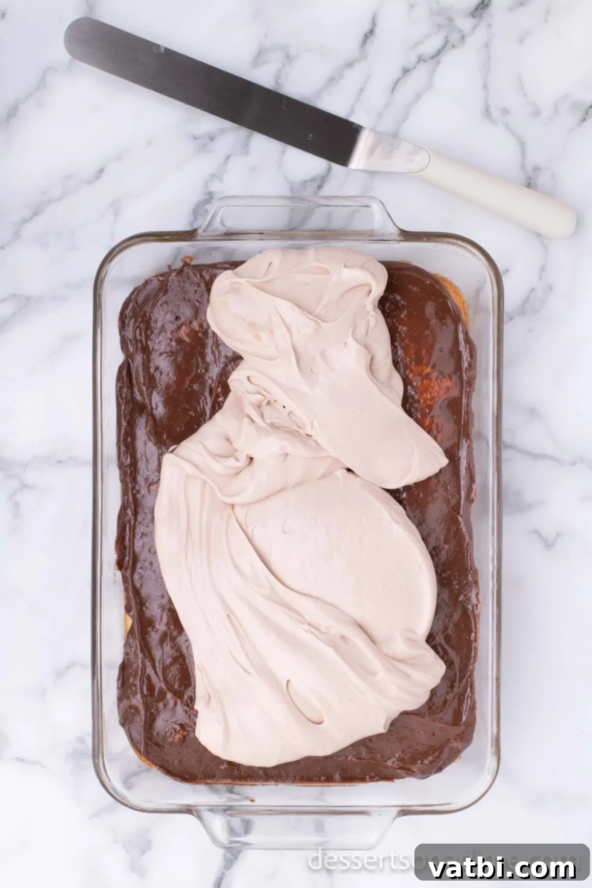 Chocolate buttercream layer on top of cake. 