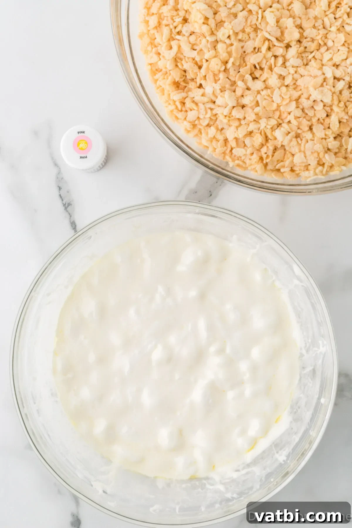 Mixing bowl with melted marshmallows and butter ready to be combined with cereal.