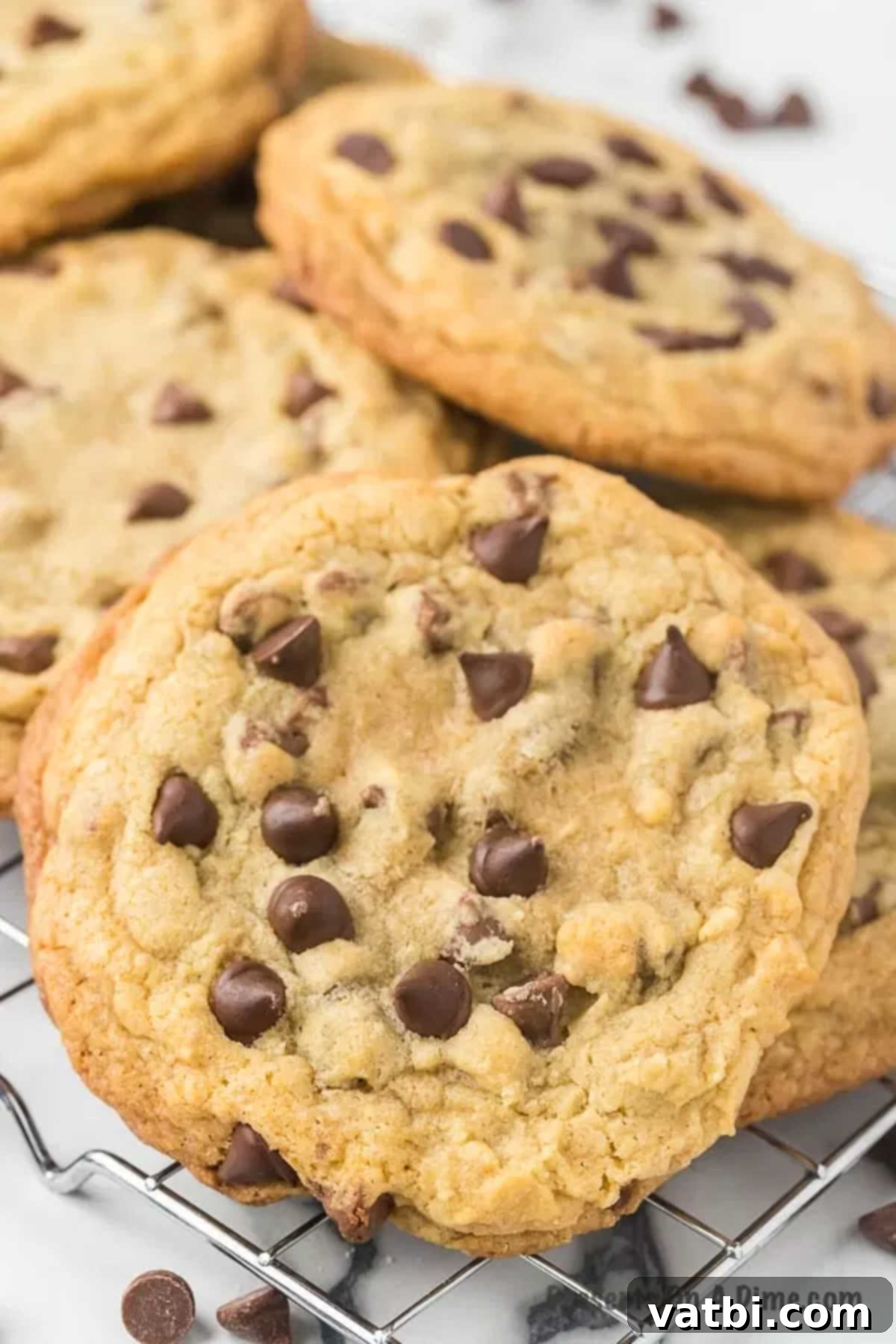 The Ultimate Crumbl Chocolate Chip Cookie Dupe 11 Crumble chocolate chip cookies on wire rack.