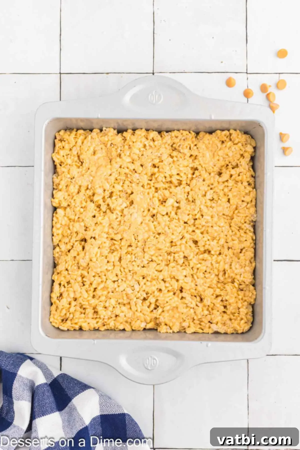Gourmet Brown Butter Rice Krispie Treats 7 Rice Krispy mixture being pressed into a prepared baking pan.