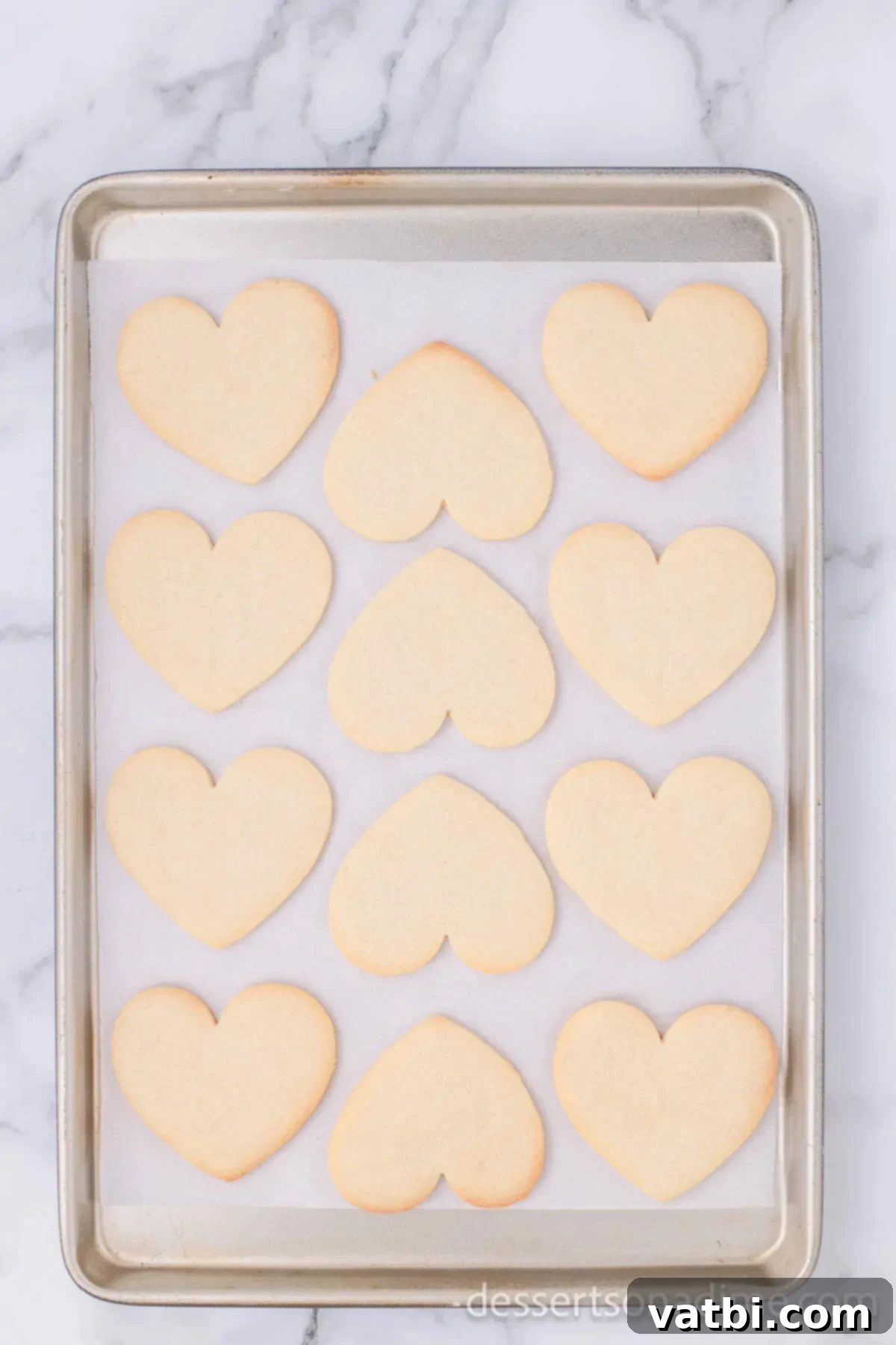 Sweetheart Sugar Cookie Delights 11 Cookies on baking sheet baked and cooling.