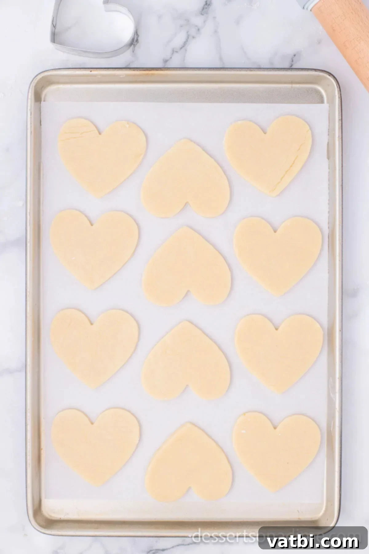Sweetheart Sugar Cookie Delights 10 Heart shaped cookies on baking sheet.