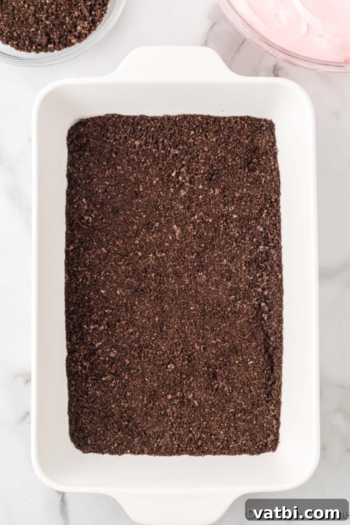 Crushed oreo cookies in baking dish. 