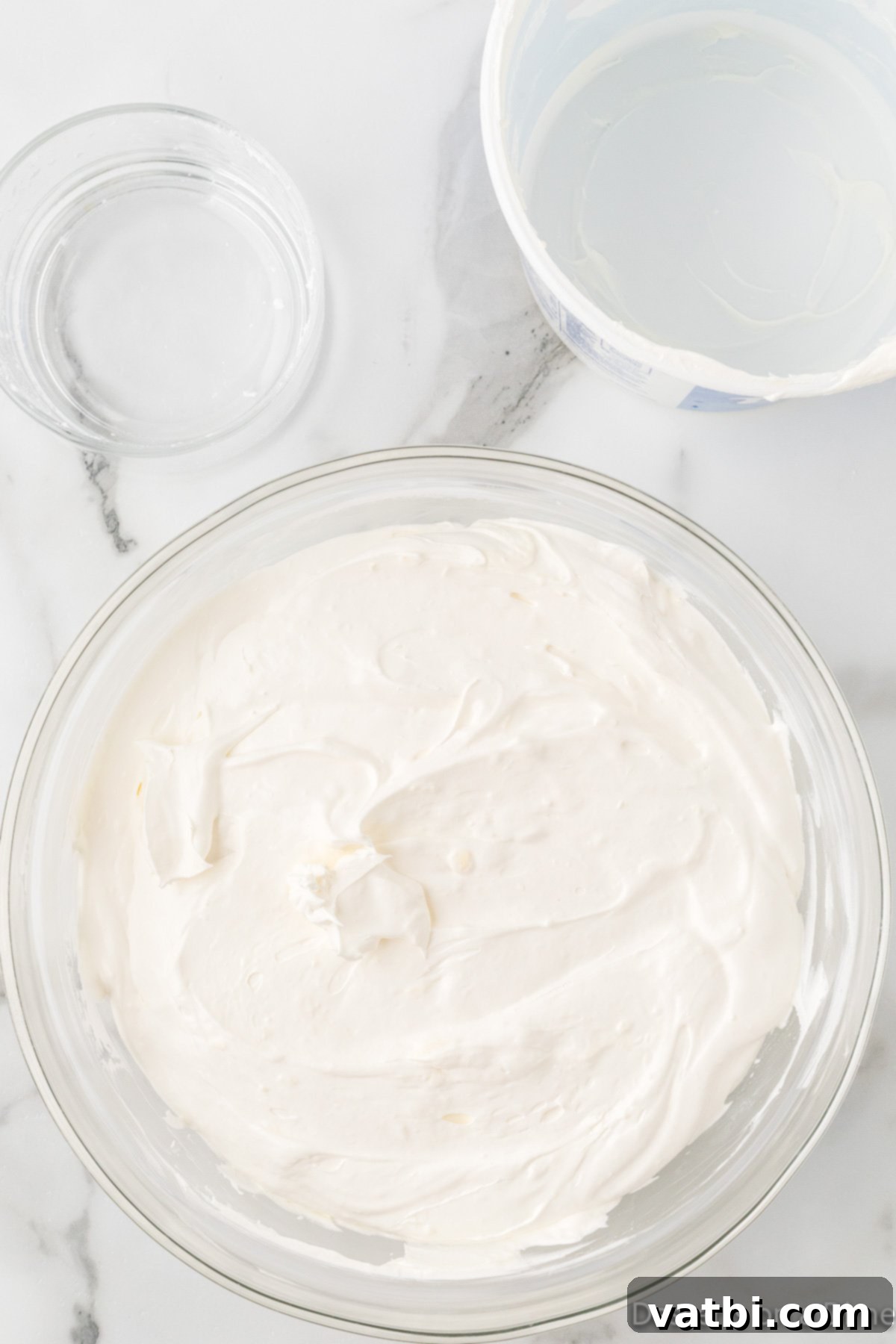 Cream cheese and butter combined in a bowl. 