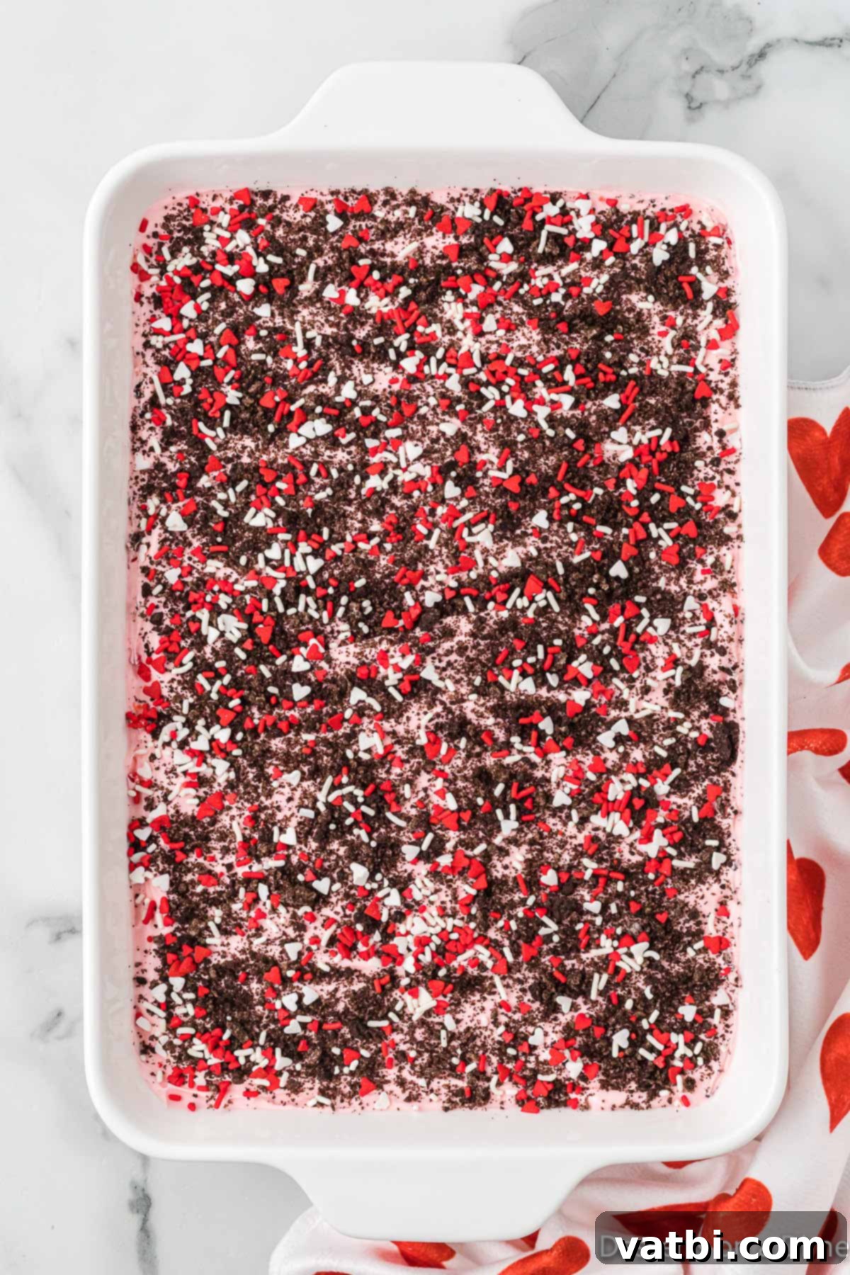 Sprinkles and crushed cookies on top of mixture. 
