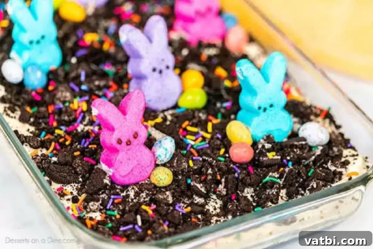Hoppy Easter Dirt Delight 7 Close-up of the Easter dirt cake decorated with more crushed Oreos, colorful Peeps, and various Easter candies.