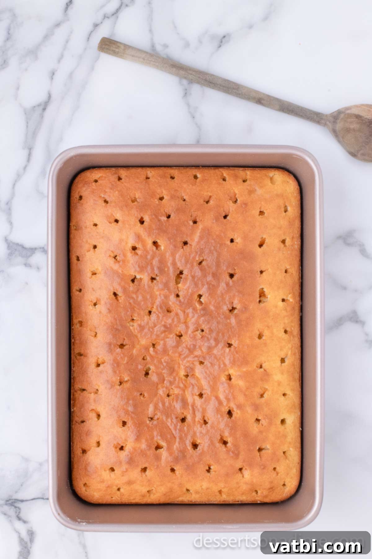 Sweet Valentine's Poke Cake 5 Cake baked with holes all over it.