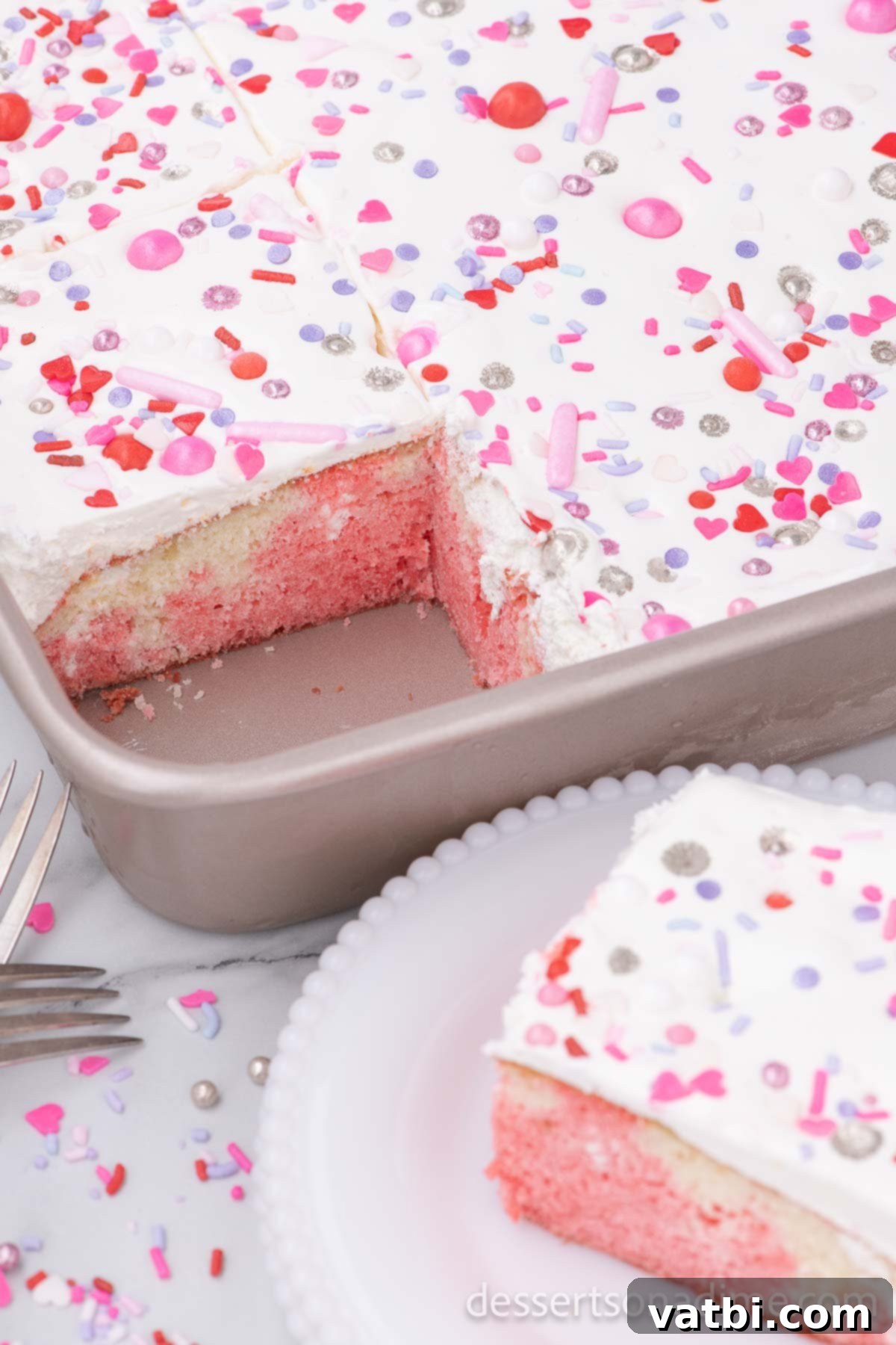 Sweet Valentine's Poke Cake 8 Cake in pan being served.